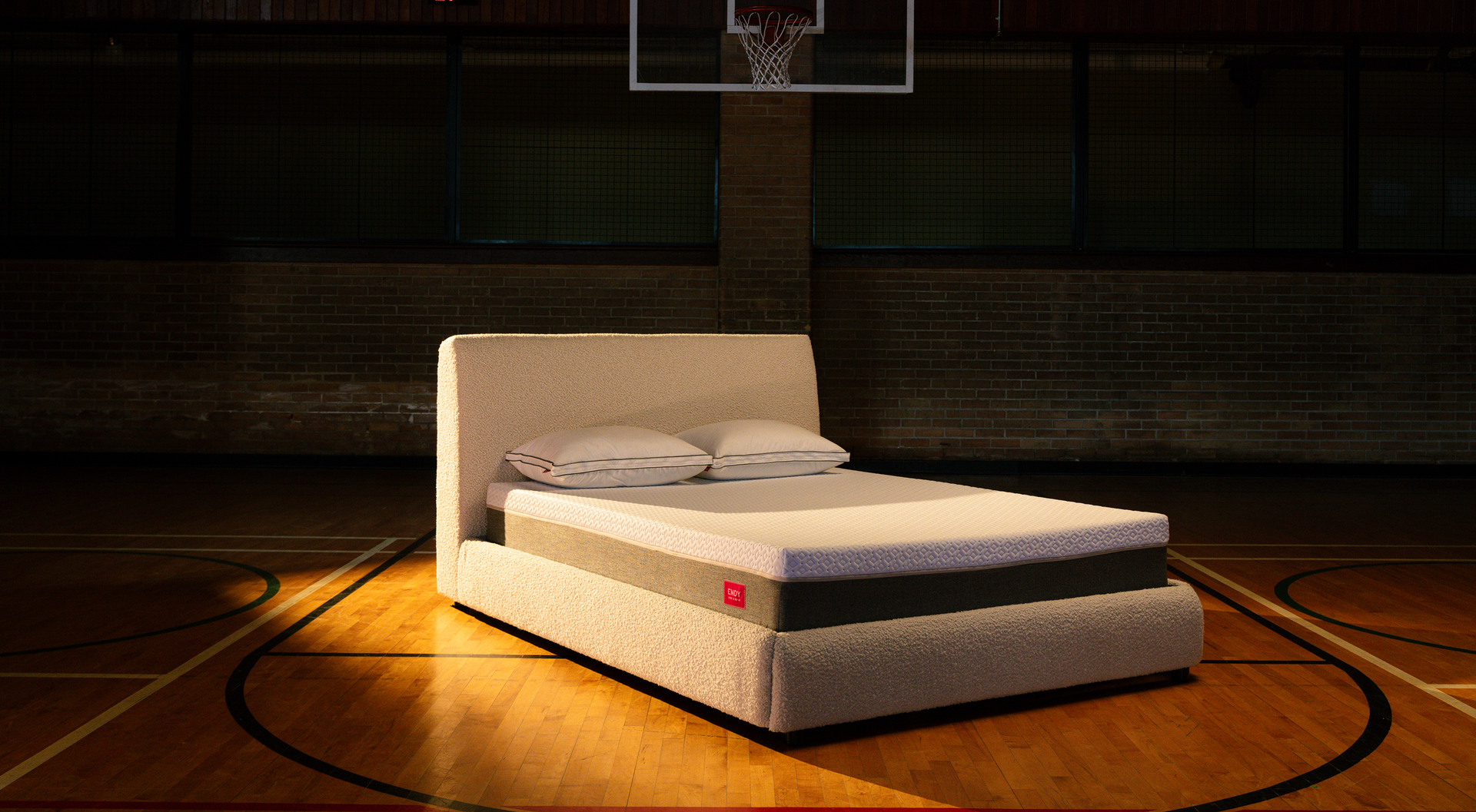Bare Endy mattress on a white upholstered bed frame in a beige bedroom