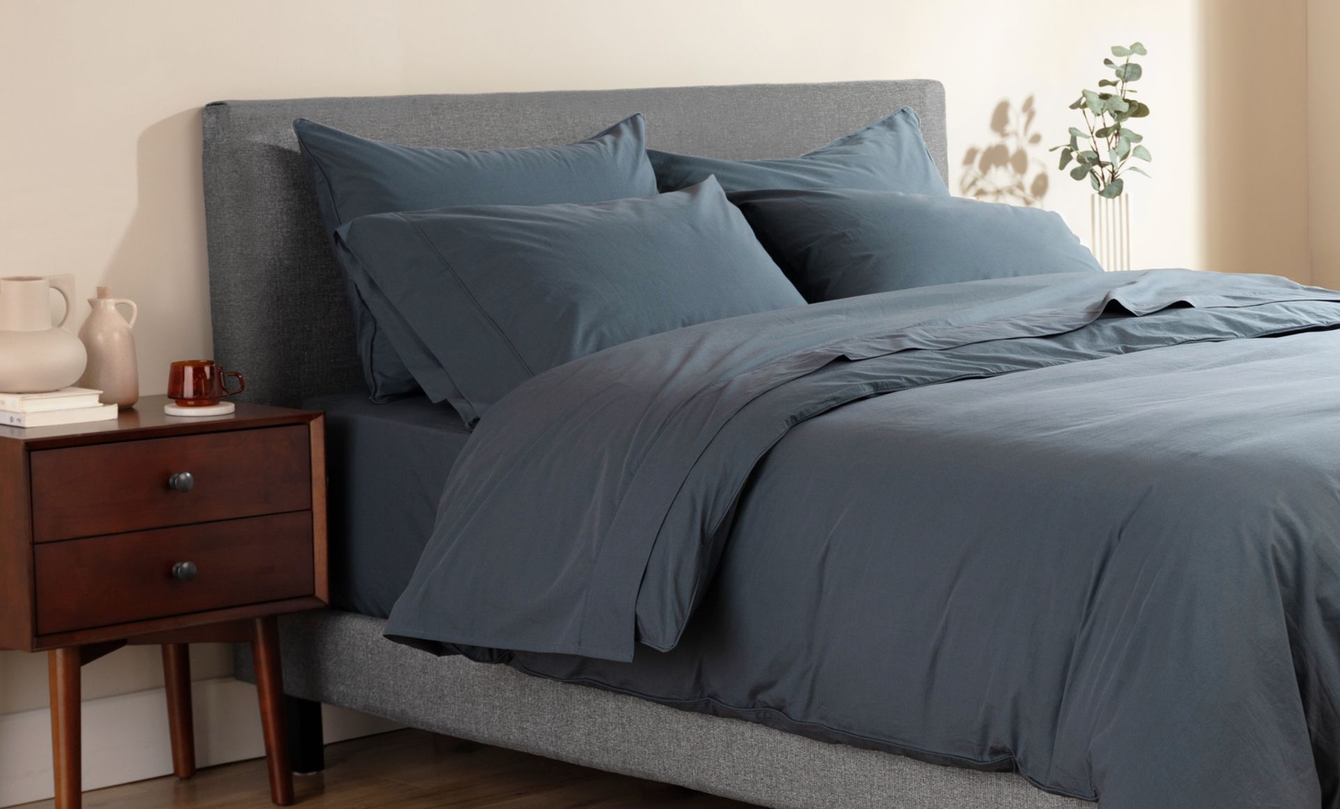 Navy blue Endy Percale Sheets on a bed and pillows