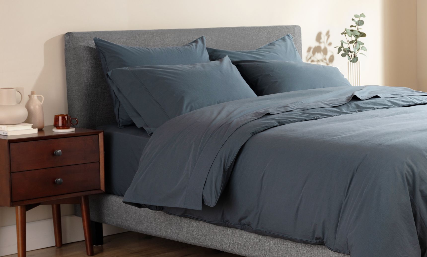 Navy blue Endy Percale Sheets on a bed and pillows