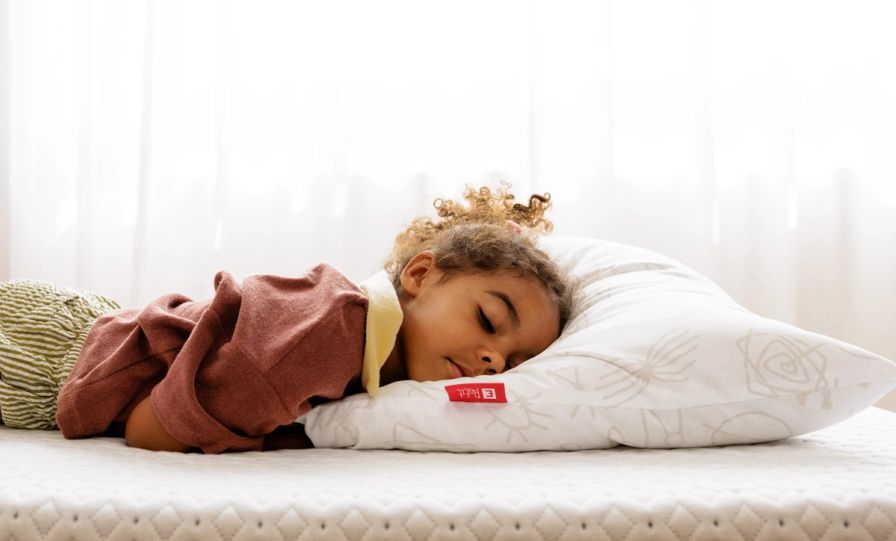 Girl sleeping on an Endy Petit Pillow