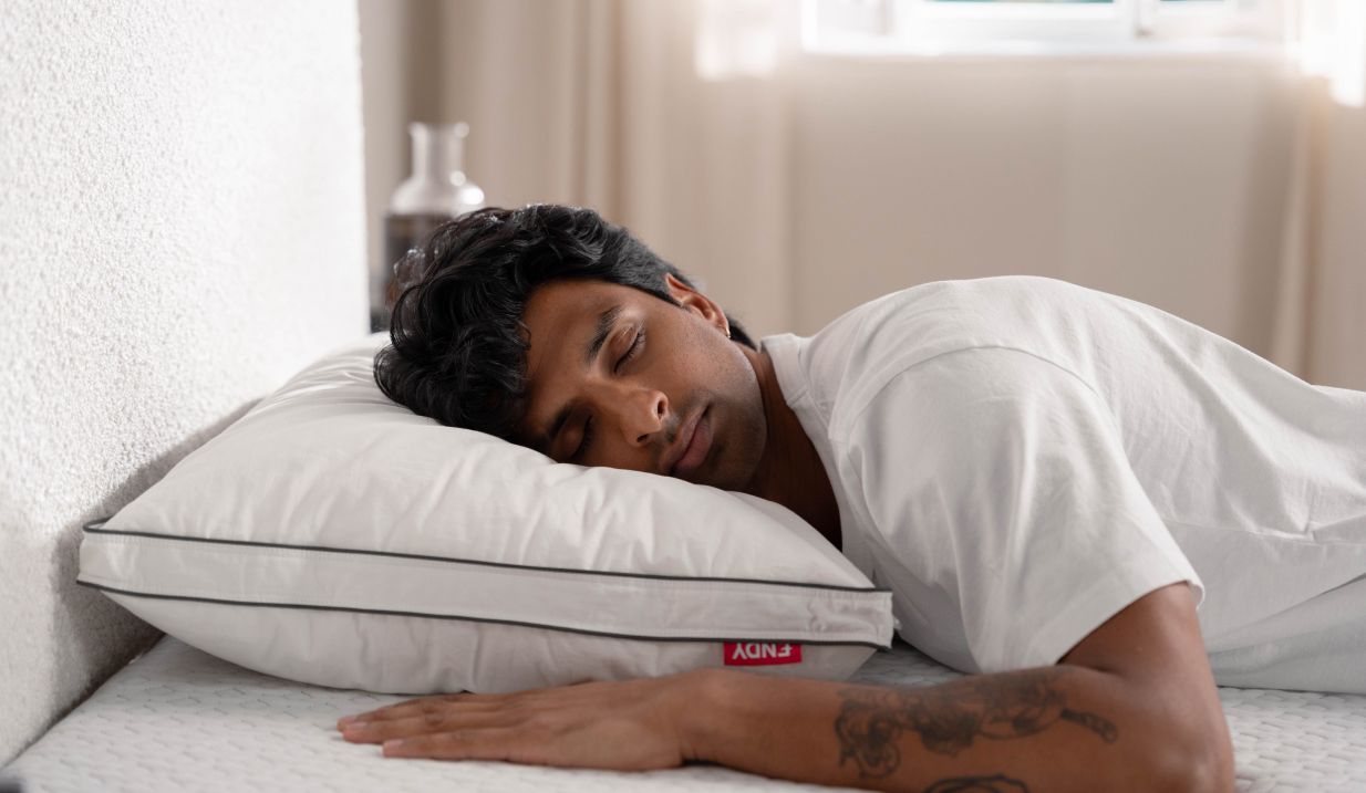 Man sleeping on his stomach on an Endy Customizable Pillow
