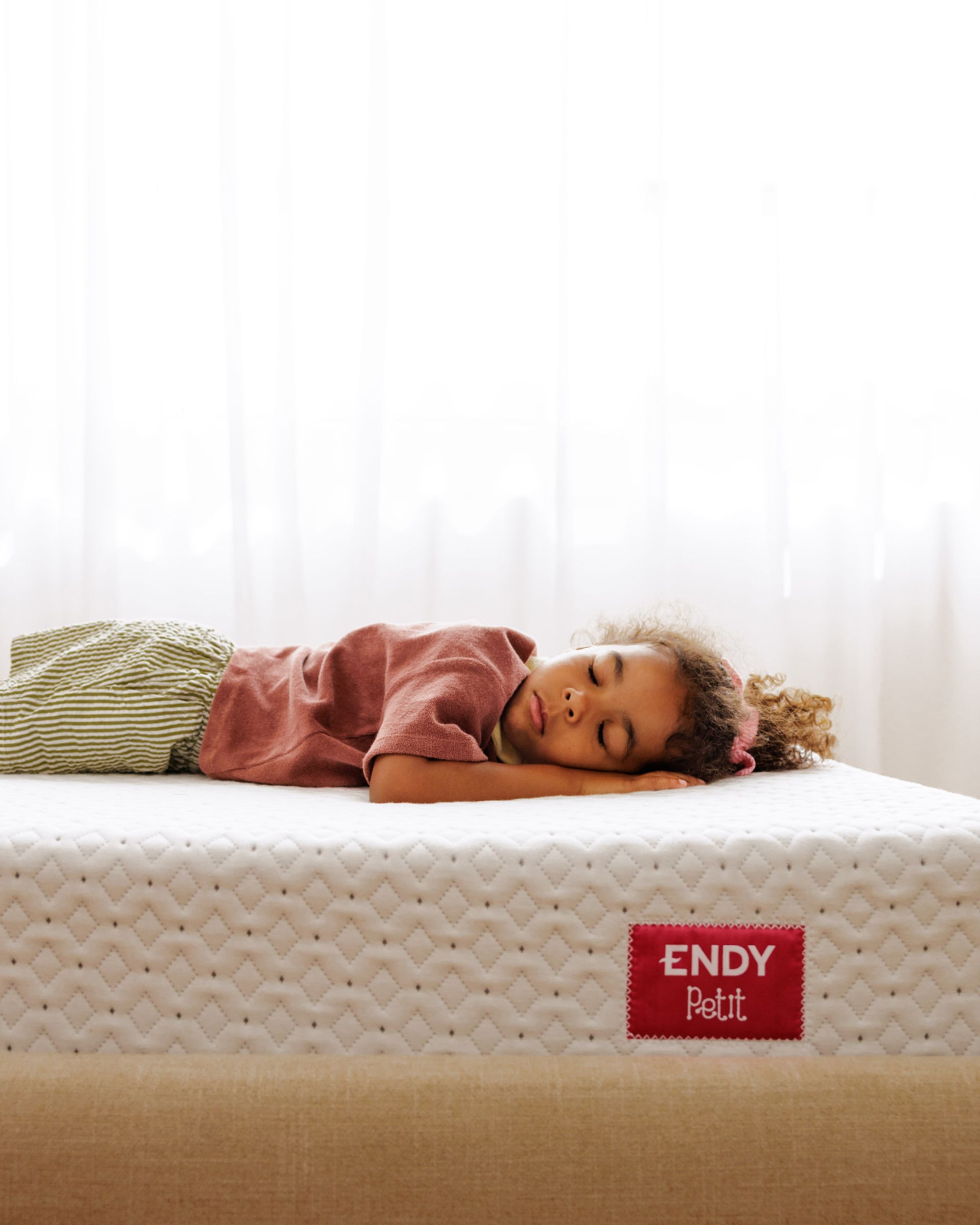 A child napping on The Endy Petit Mattress.