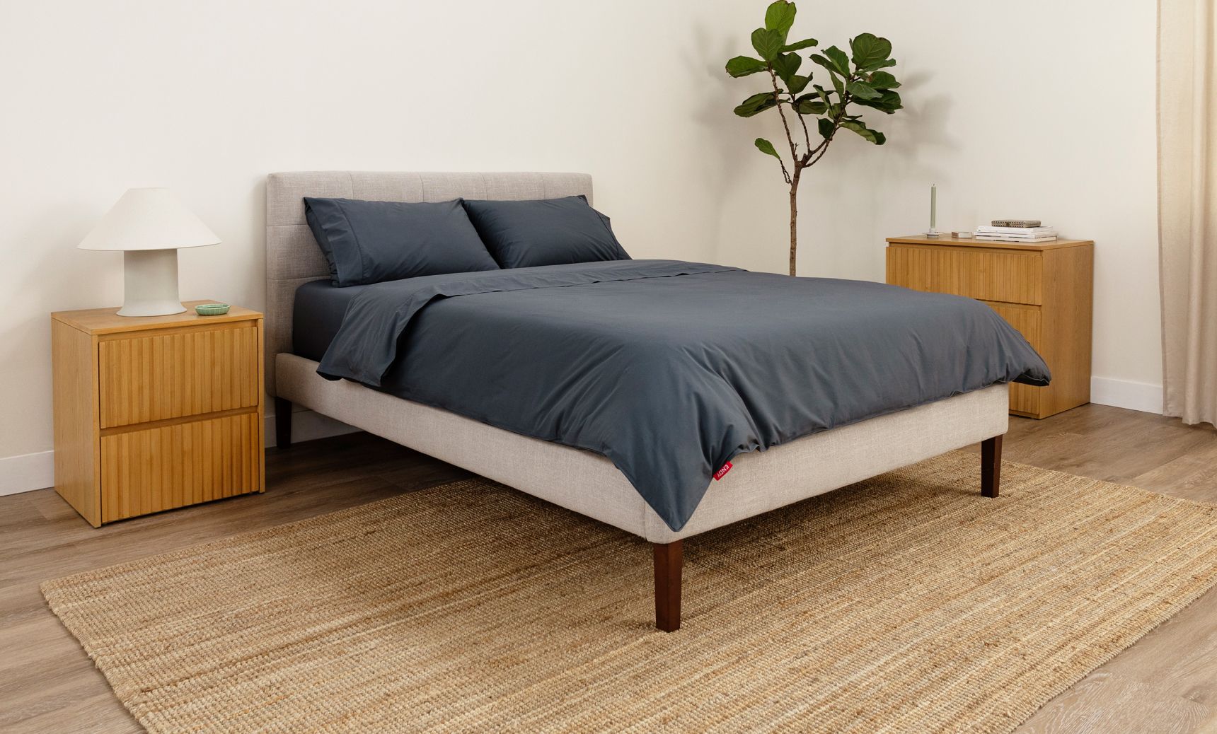 Bedroom showcasing the tufted upholstered bed frame in ash grey colourway.