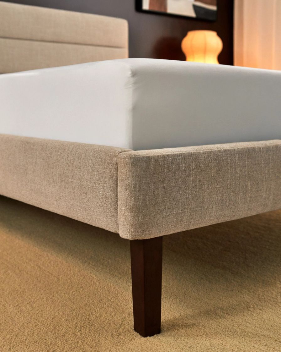 Close up detail shot of channel upholstered bed frame in alabaster colourway supporting the Endy Mattress.