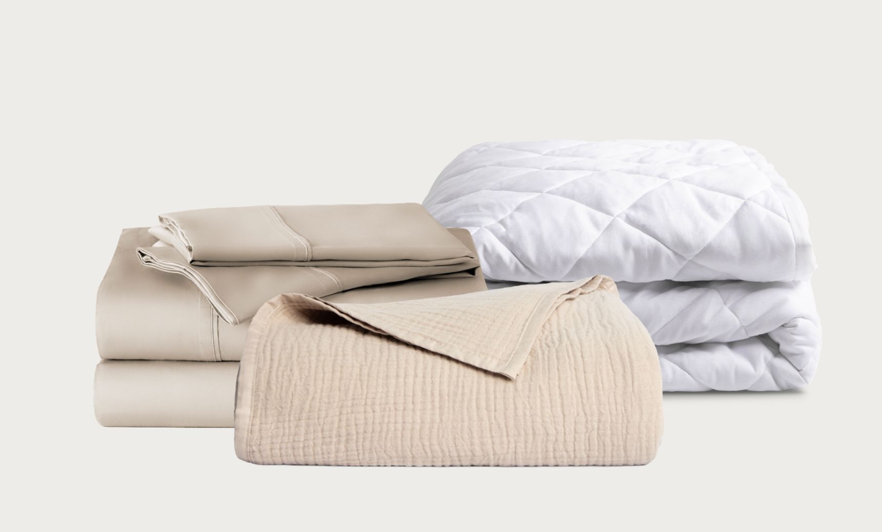 The Refresh Bundle includes sheet set and muslin blanket in sandbanks color and white quilted mattress protector