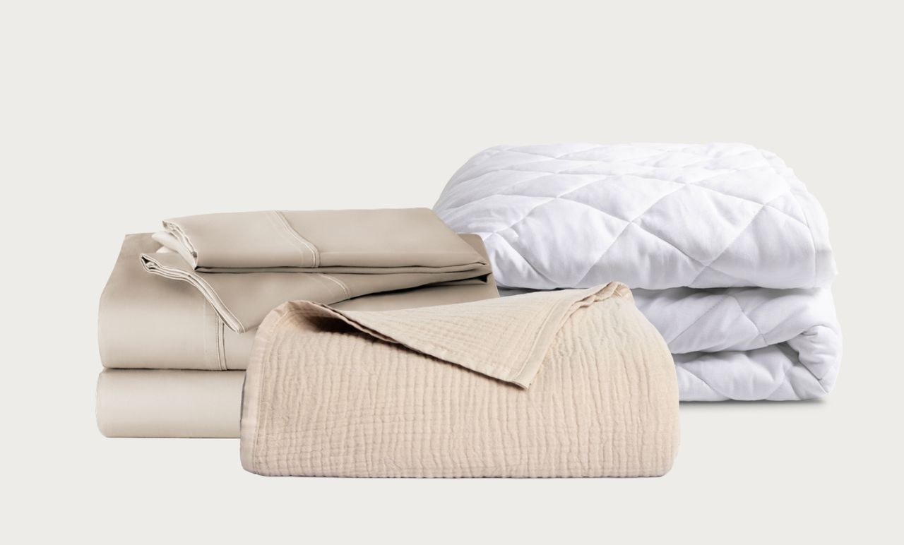 The Refresh Bundle includes sheet set and muslin blanket in sandbanks color and white quilted mattress protector