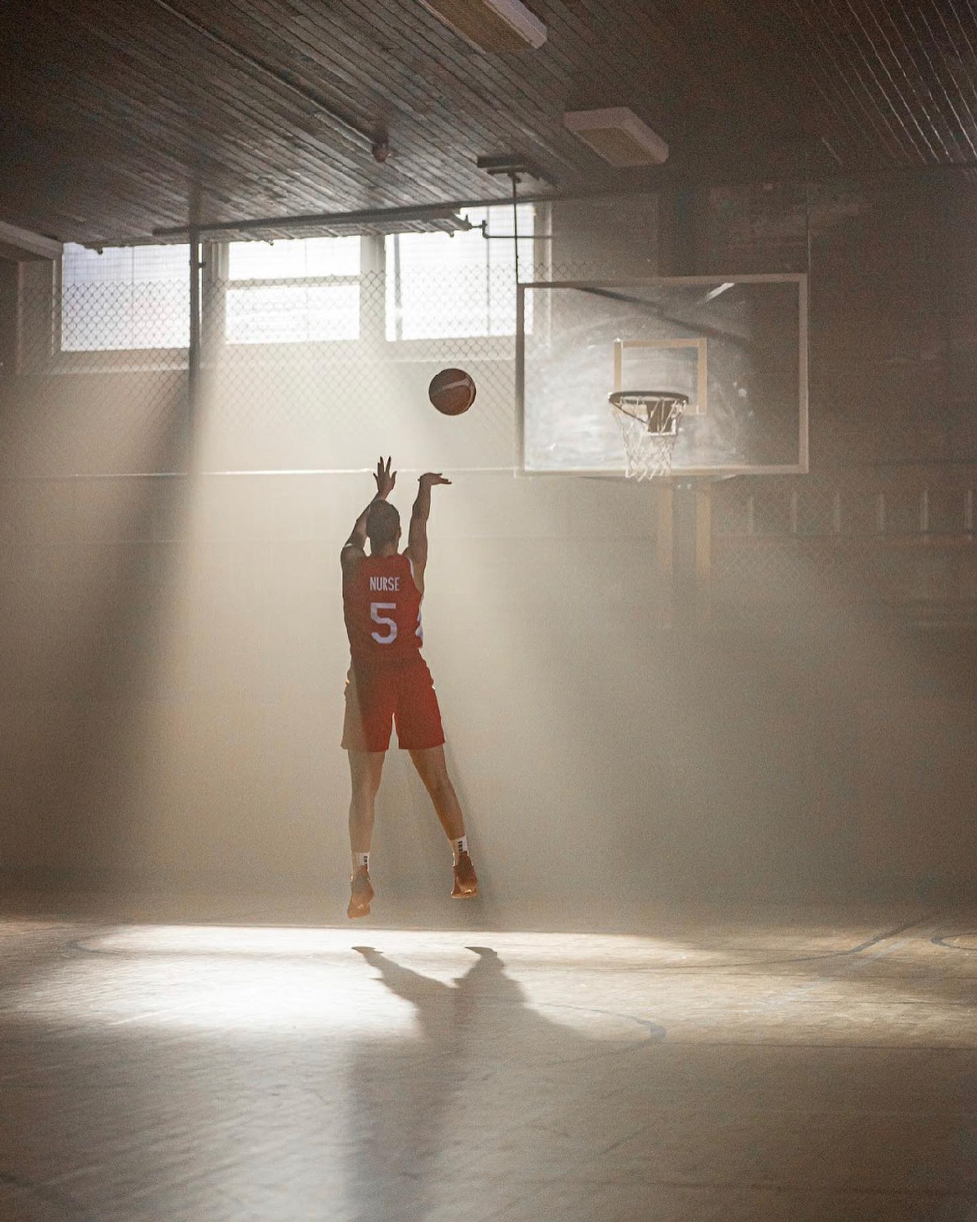 Kia Nurse shooting a basket in an empty gymnasium, morning light