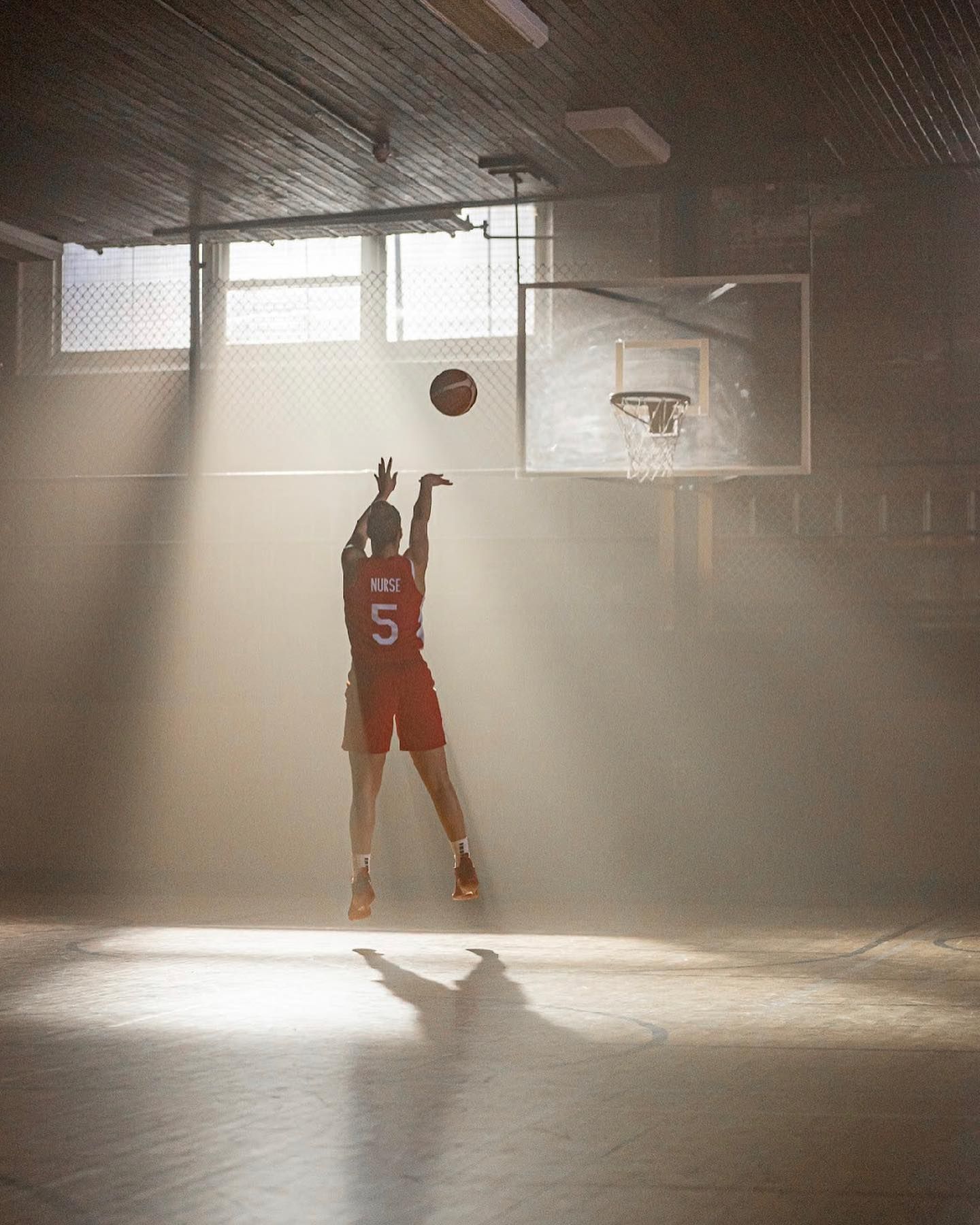 Kia Nurse shooting a basket in an empty gymnasium, morning light