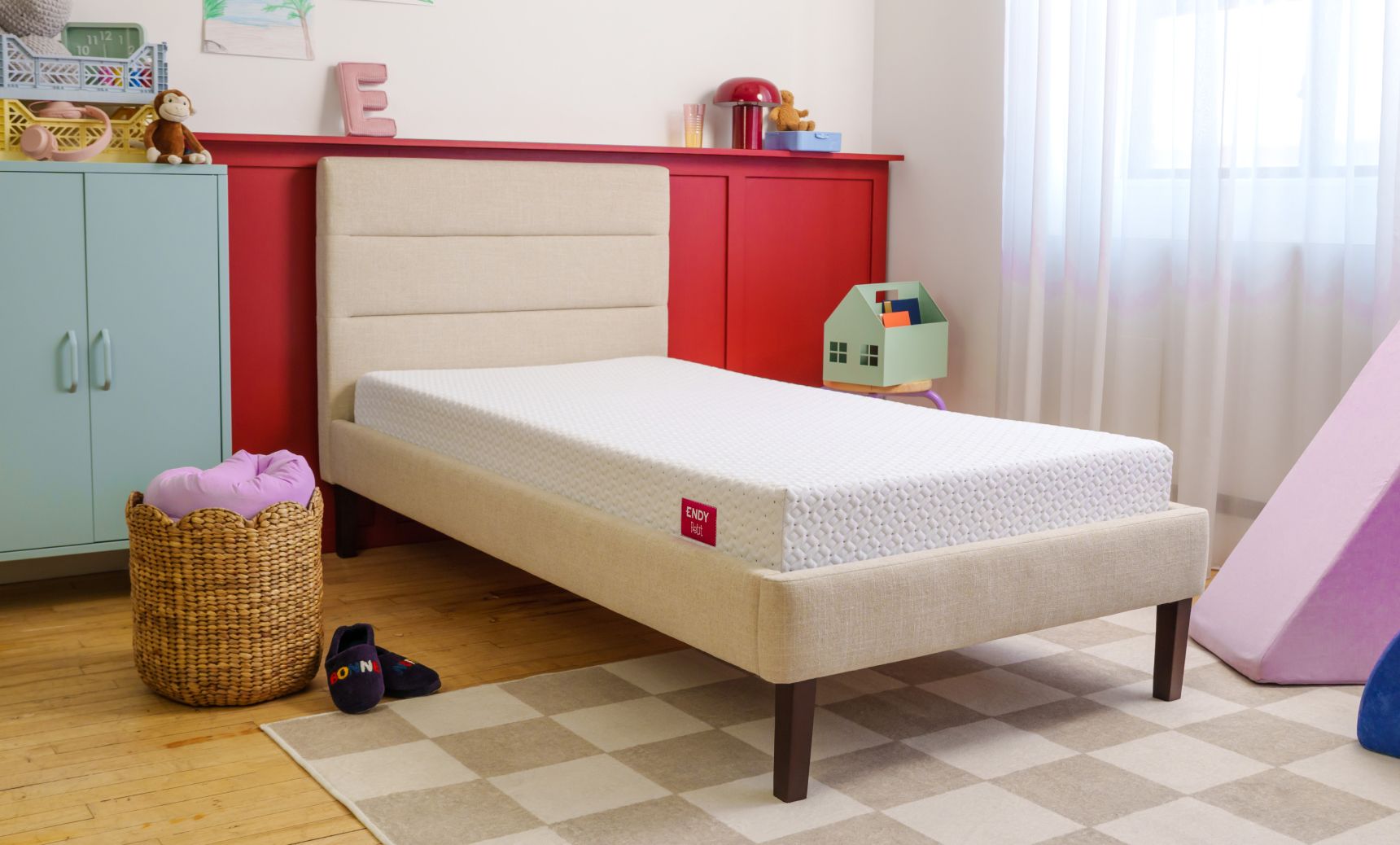 Bare Endy Petit mattress on a white upholstered bed frame in a child's bedroom