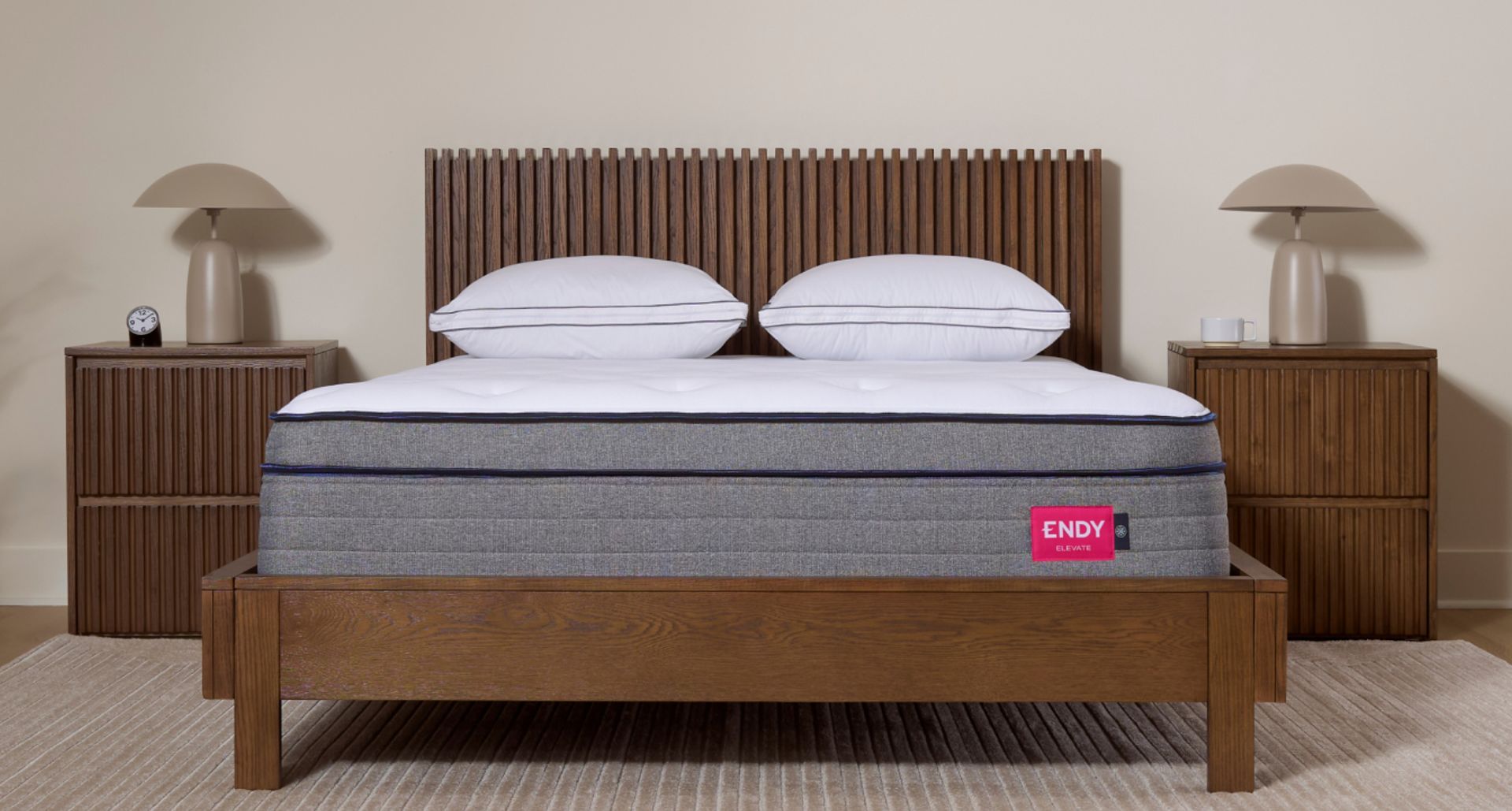 Plush Endy Elevate Hybrid on a dark wooden bed frame