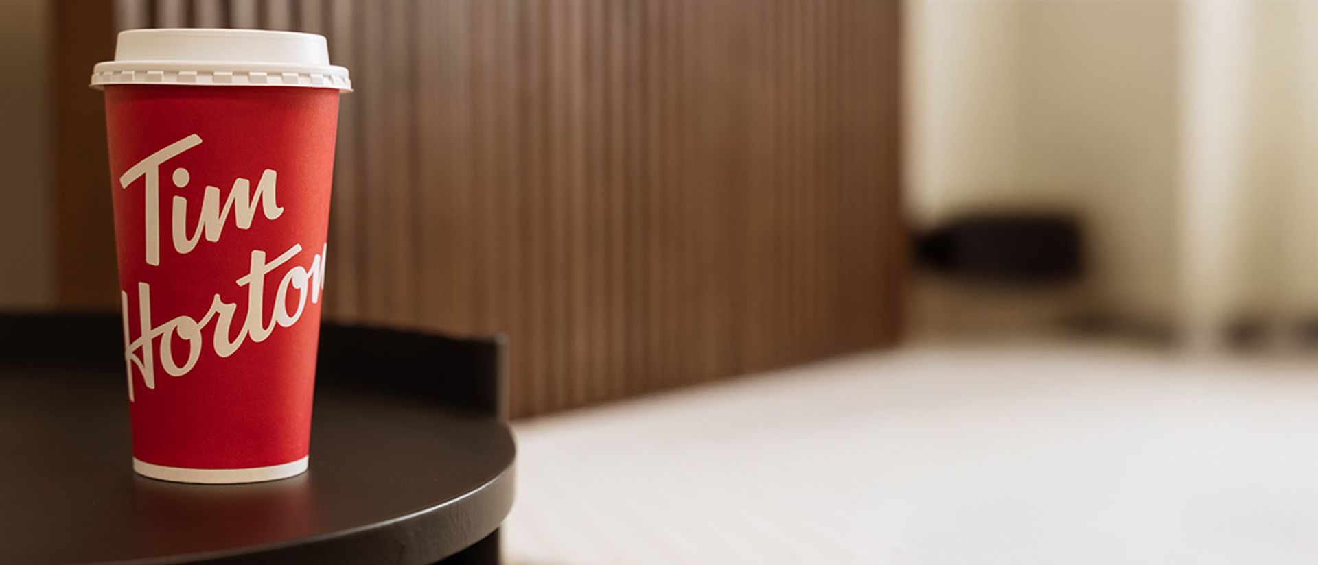 Tim Hortons coffee cup in front of Endy Wooden Bed