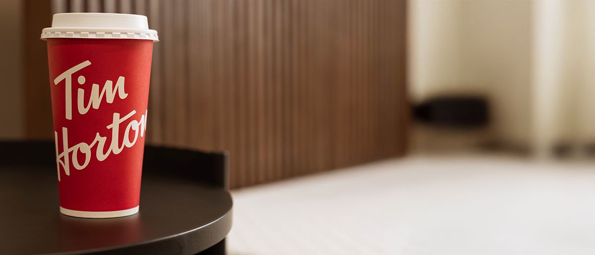 Tim Hortons coffee cup in front of Endy Wooden Bed