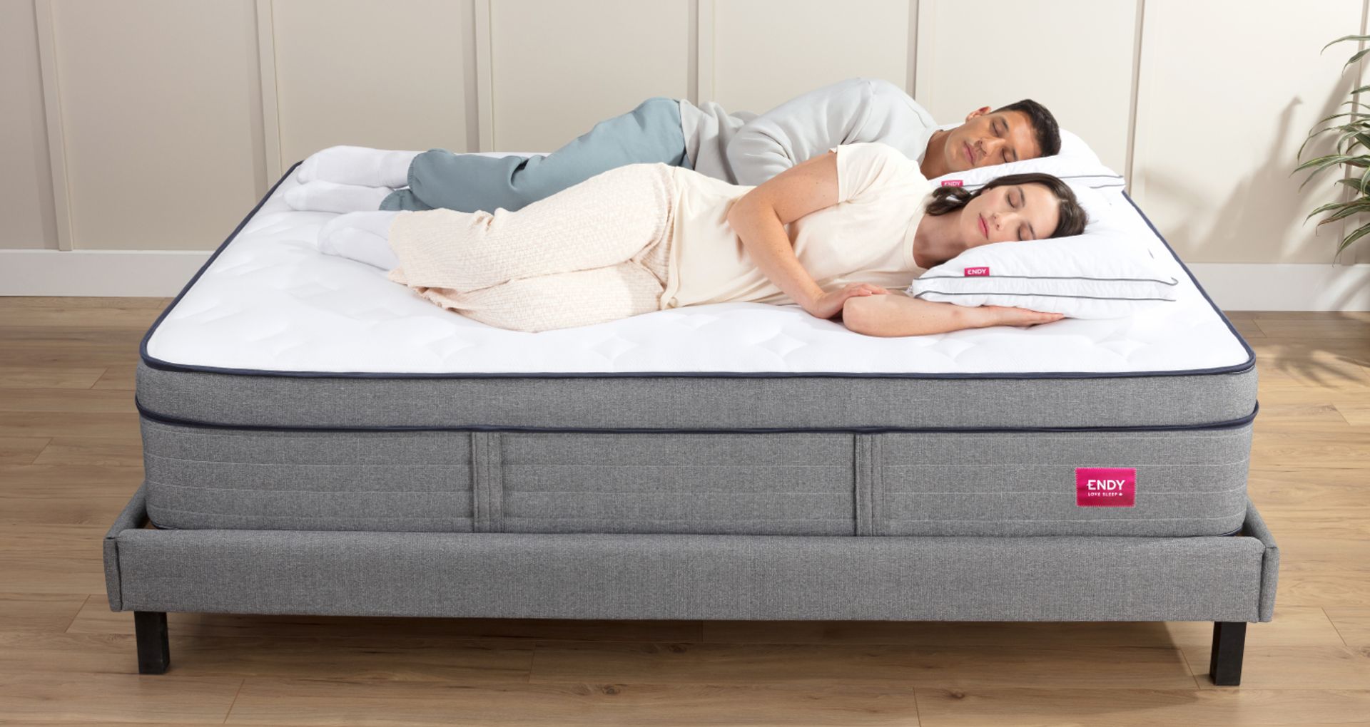 A couple laying next to each other on their sides, on an Endy Hybrid Mattress.