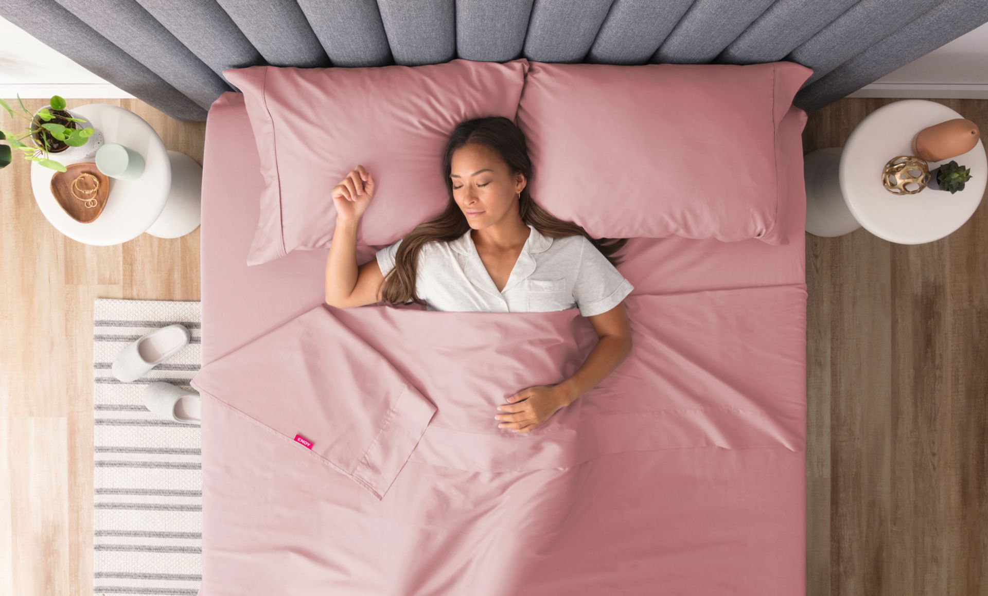 Woman sleeping peacefully under pink Endy Sheets