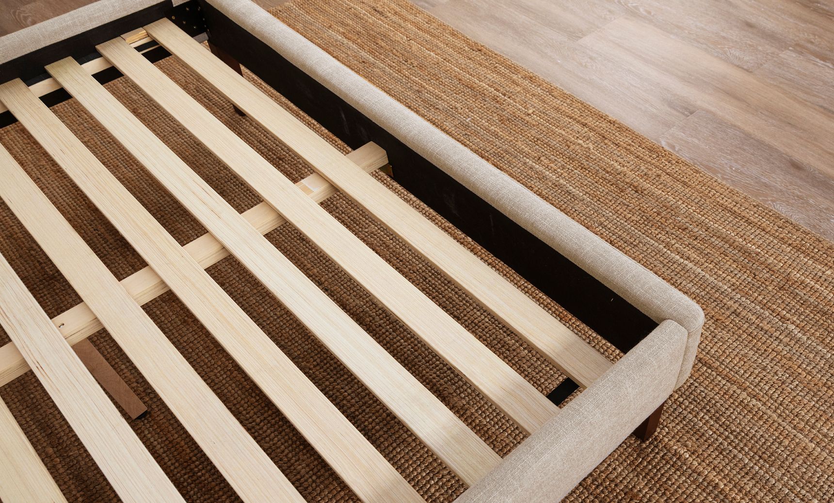 Close-up of the ash grey bed frame and wooden support slats.