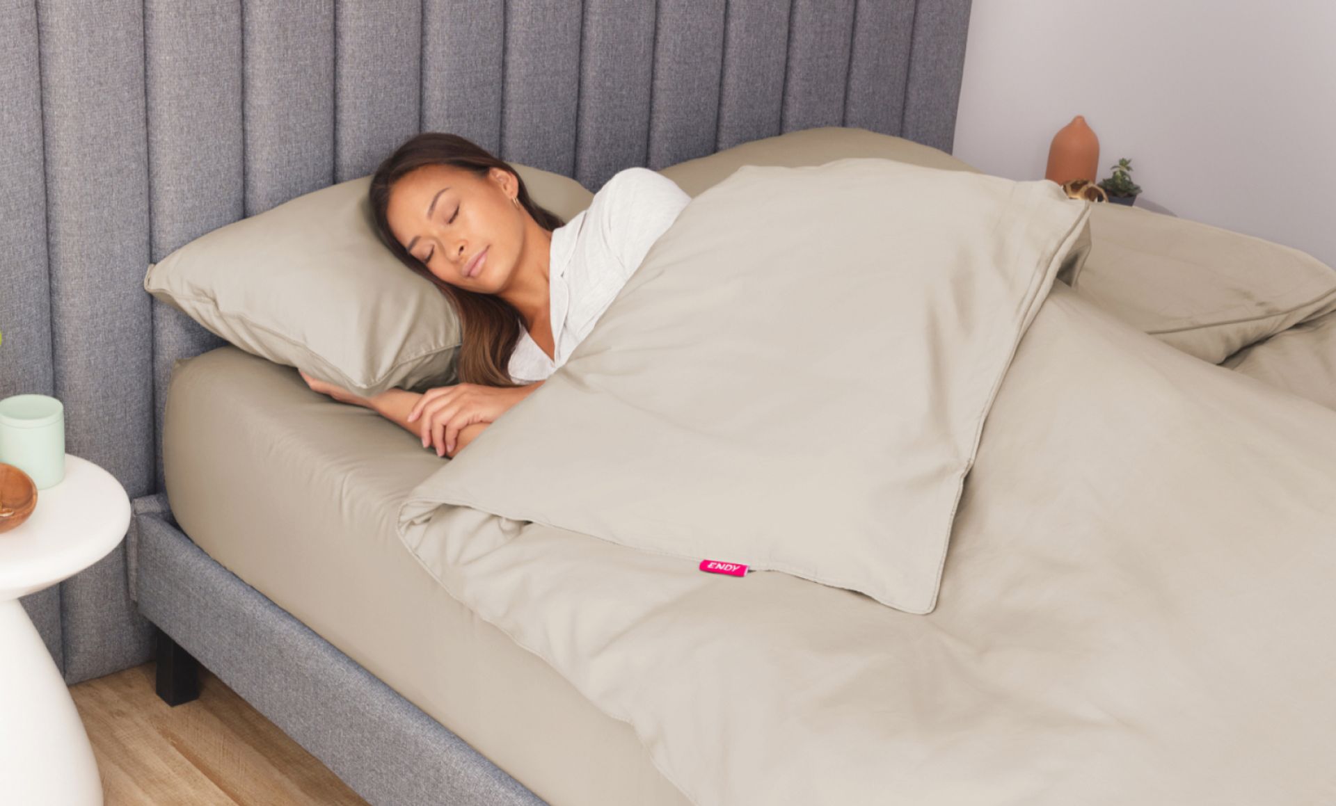 Woman sleeping peacefully under beige Endy Sateen sheets