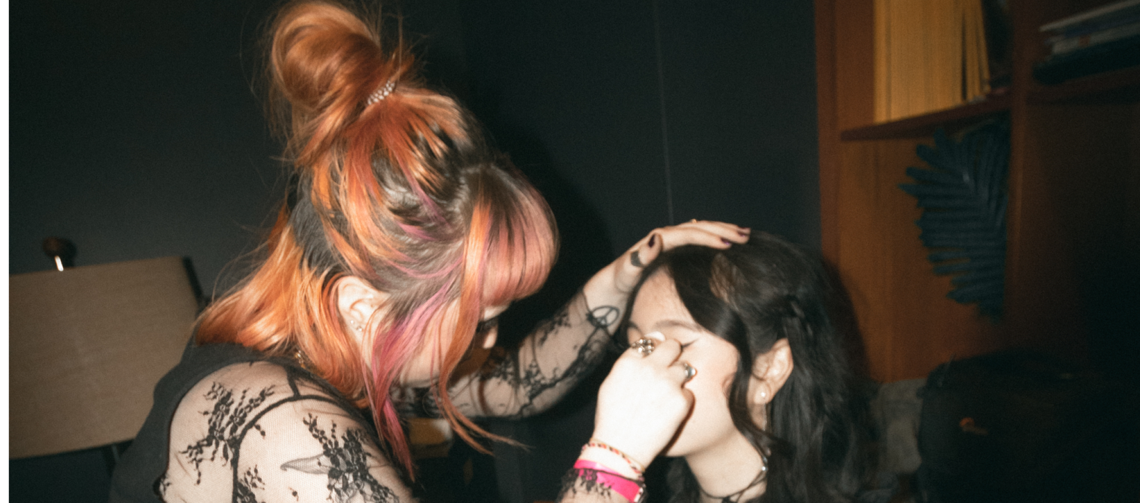 Makeup artist fixing makeup on girl