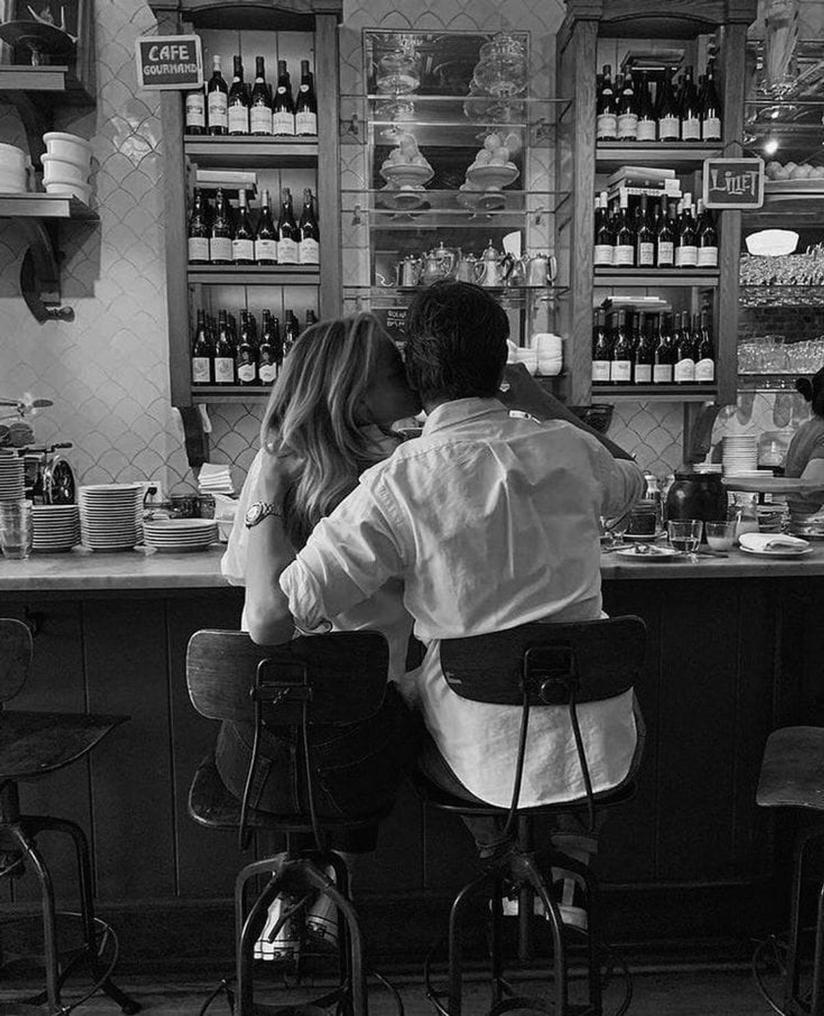 A couple sitting close together at a café counter