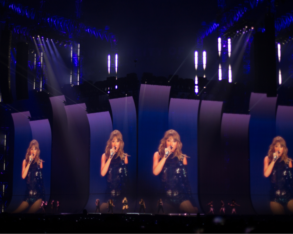 taylor swift performing, project on stage screens