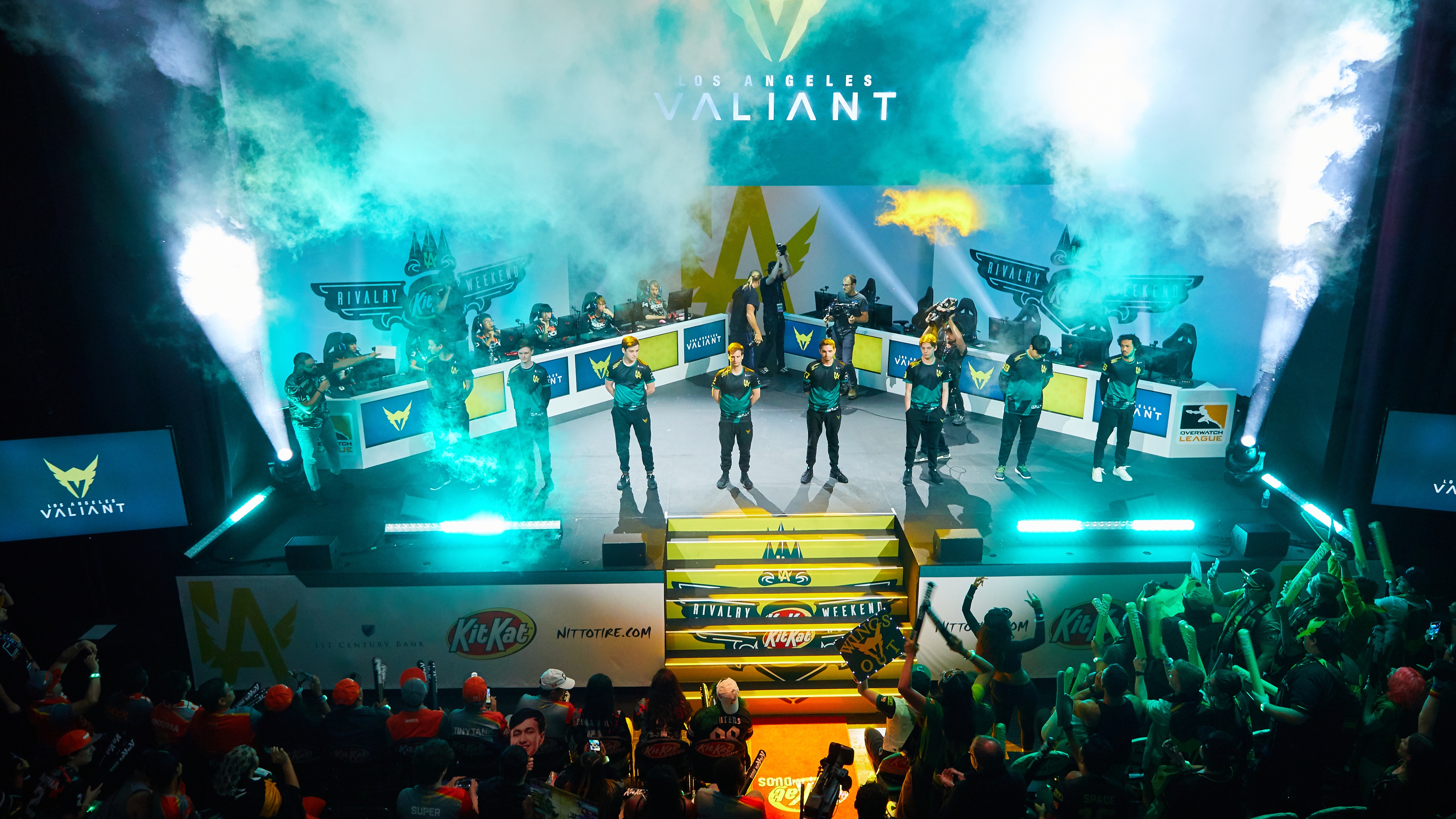 Valiant team on stage with fog and green lighting