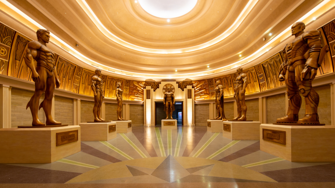 room with statues of superheroes