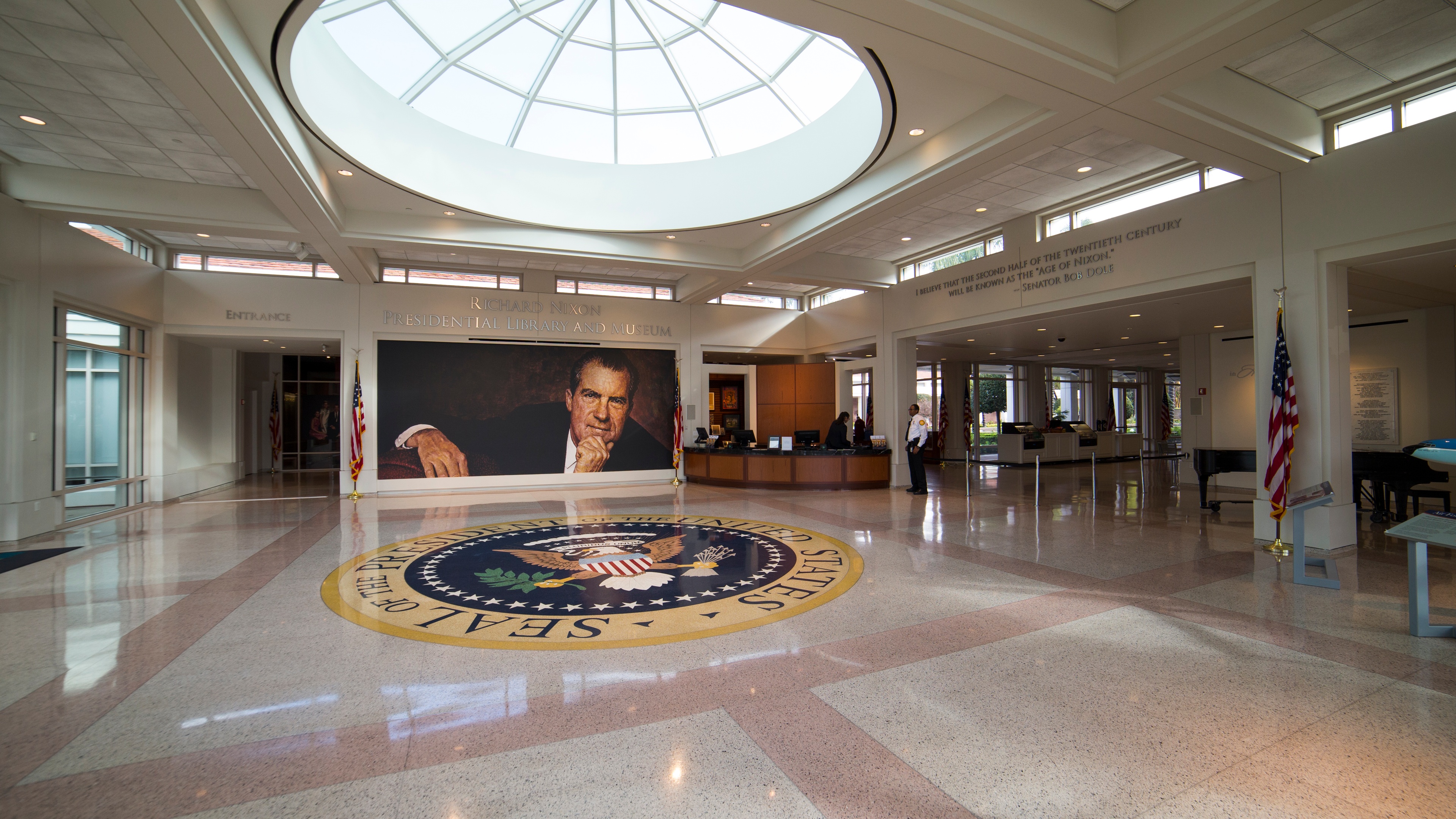 Entrance to museum with Richard Nixon photo on wall with US seal on floor
