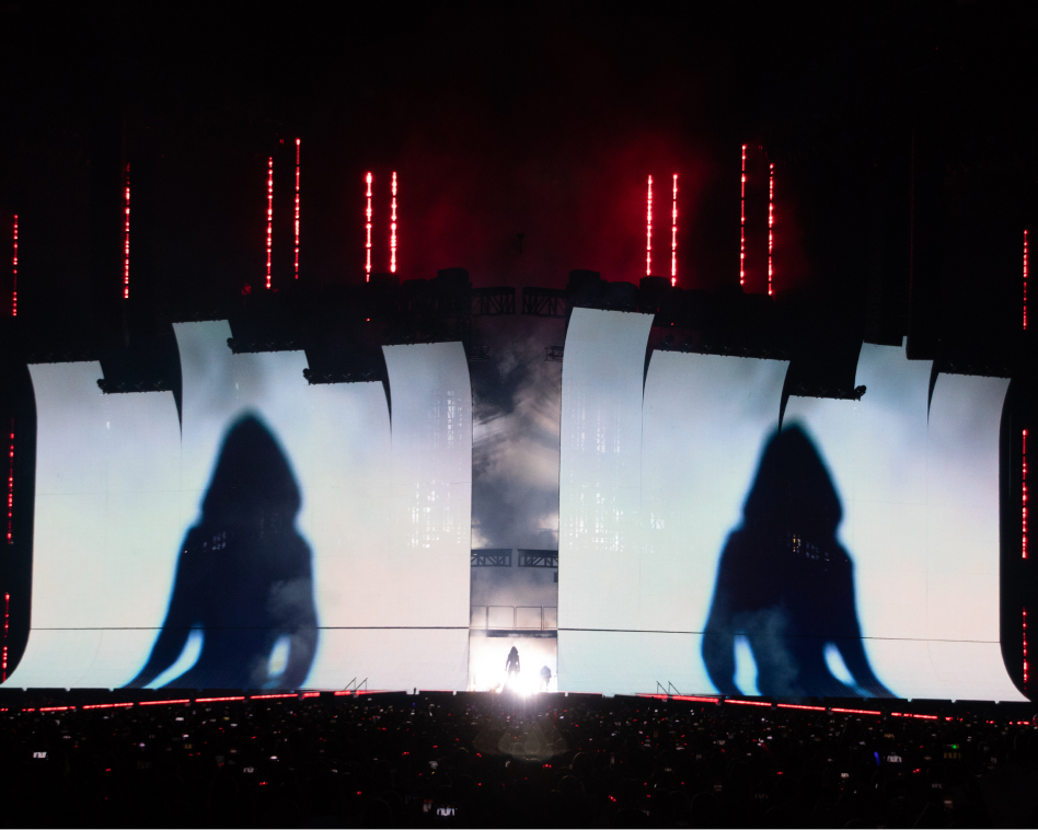 taylor swift's silhouette projected on stage screens