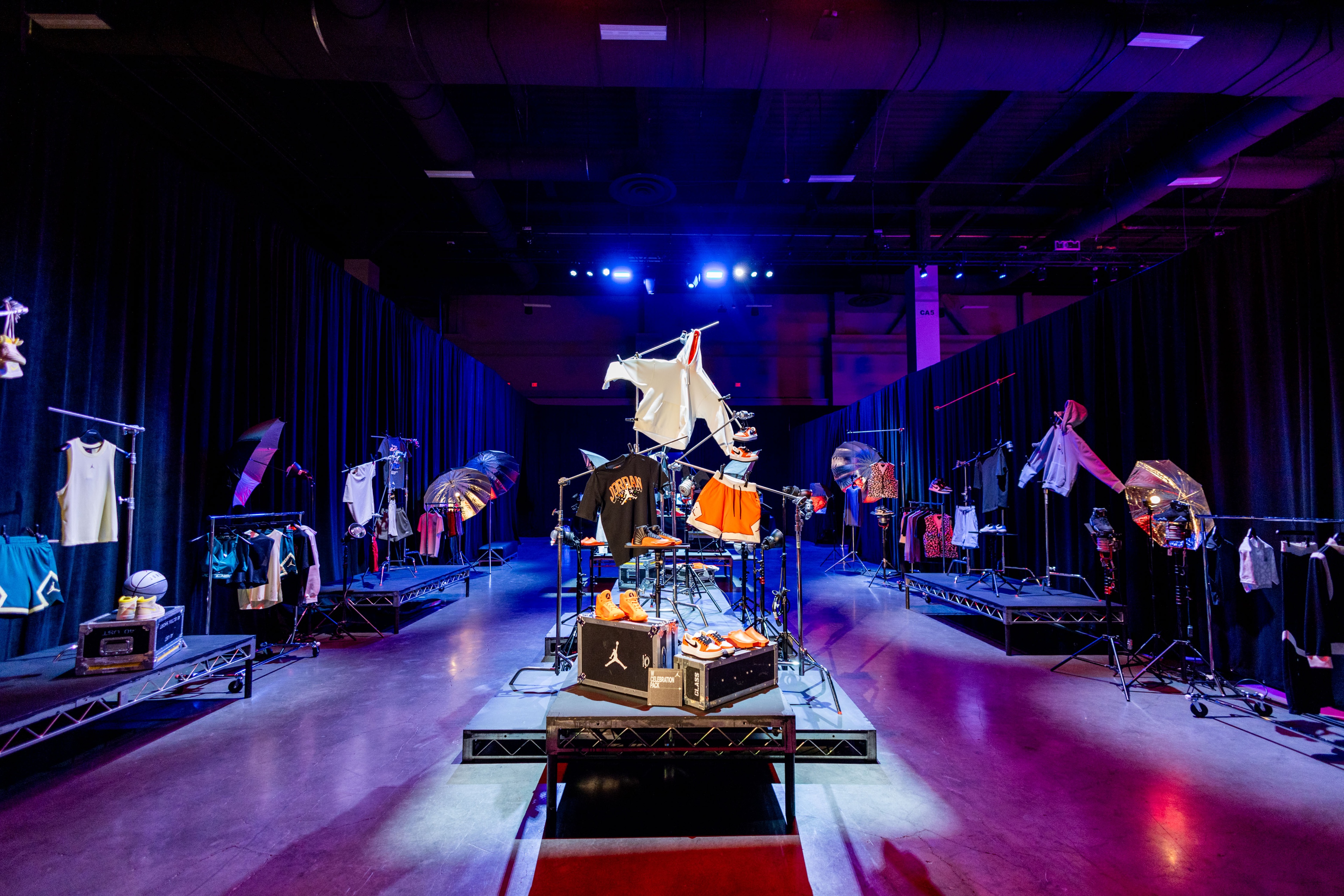 Nike Jordan Brand WNBA All-Star Weekend Las Vegas display of latest merchandise placed on top of platforms and sitting atop show utlity cases and hanging from deconstructed racks