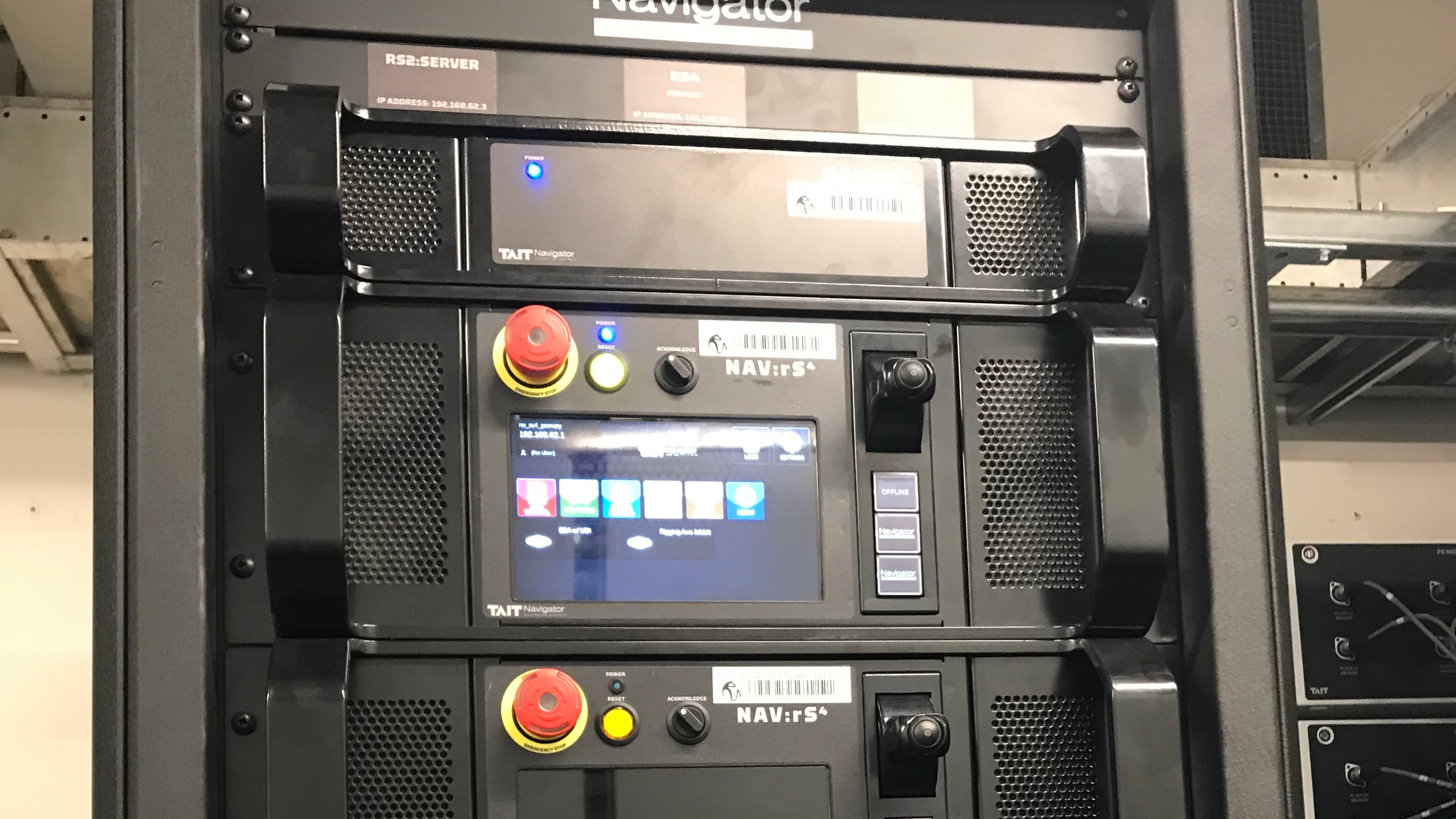 Stack of interfaces with e-stop buttons and inputs using TAIT Navigator Automation Platform