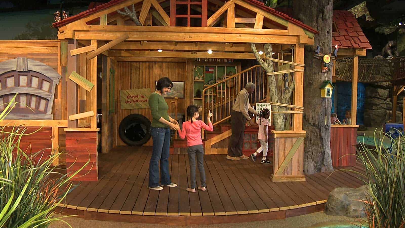 Interactive room with wooden house and family
