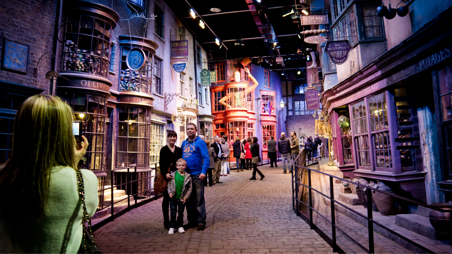 family standing inside of harry potter exhibit