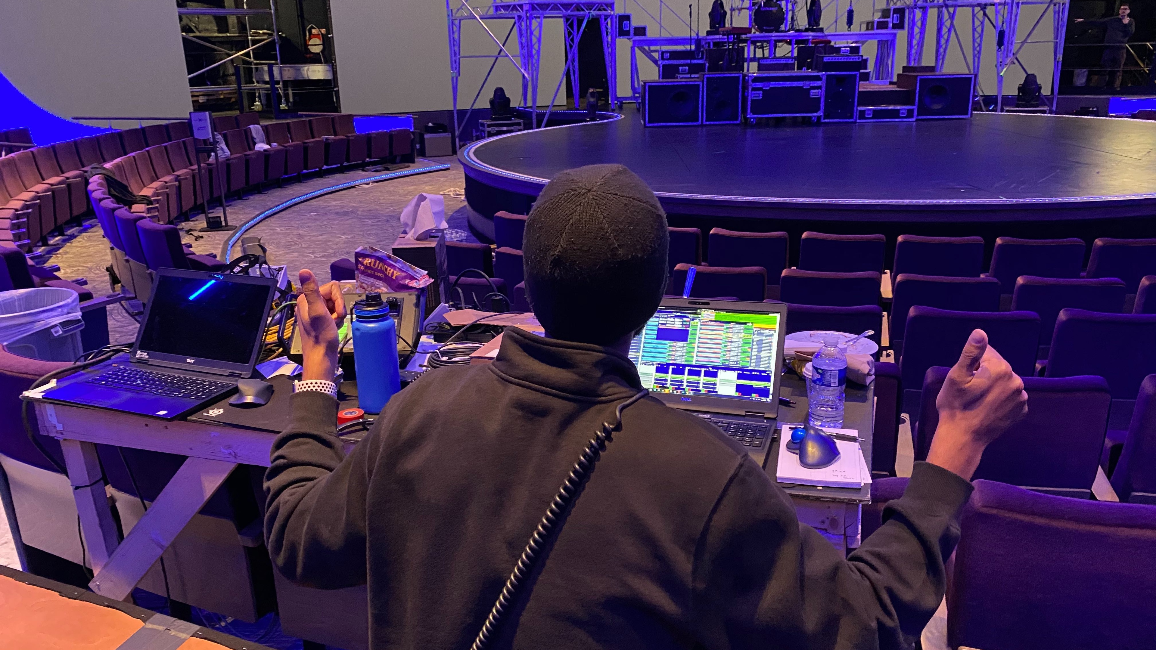 Person with thumbs up controlling stage with software