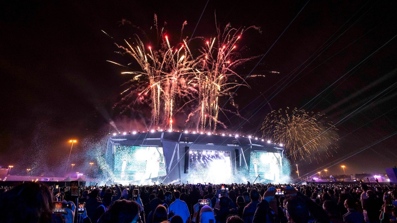 Stage with fireworks in front of large crowd