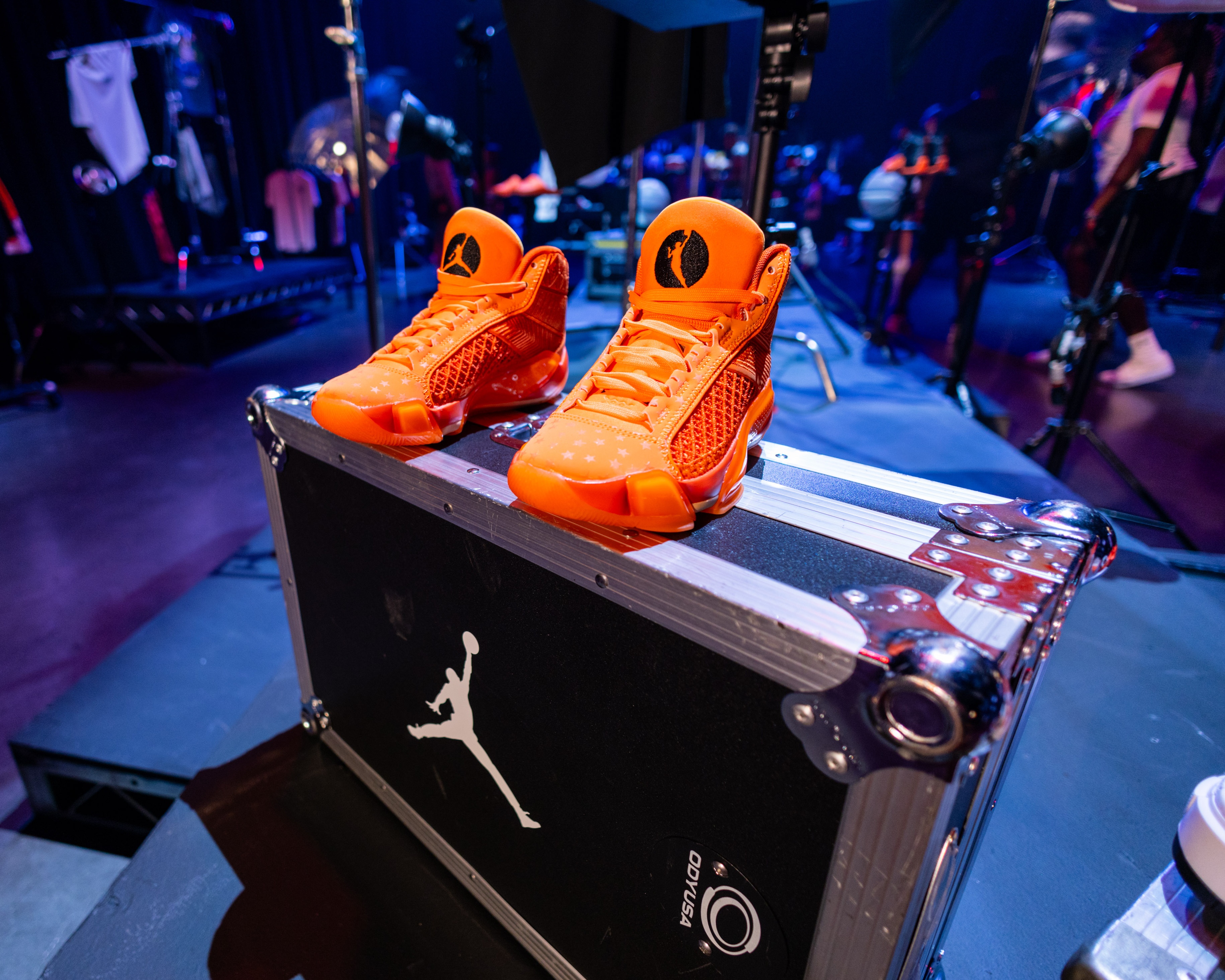 Nike Jordan Brand WNBA All-Star Weekend Las Vegas a pair of bright orange sneakers sitting atop a show utility case with a white Jordan icon stamped in the center