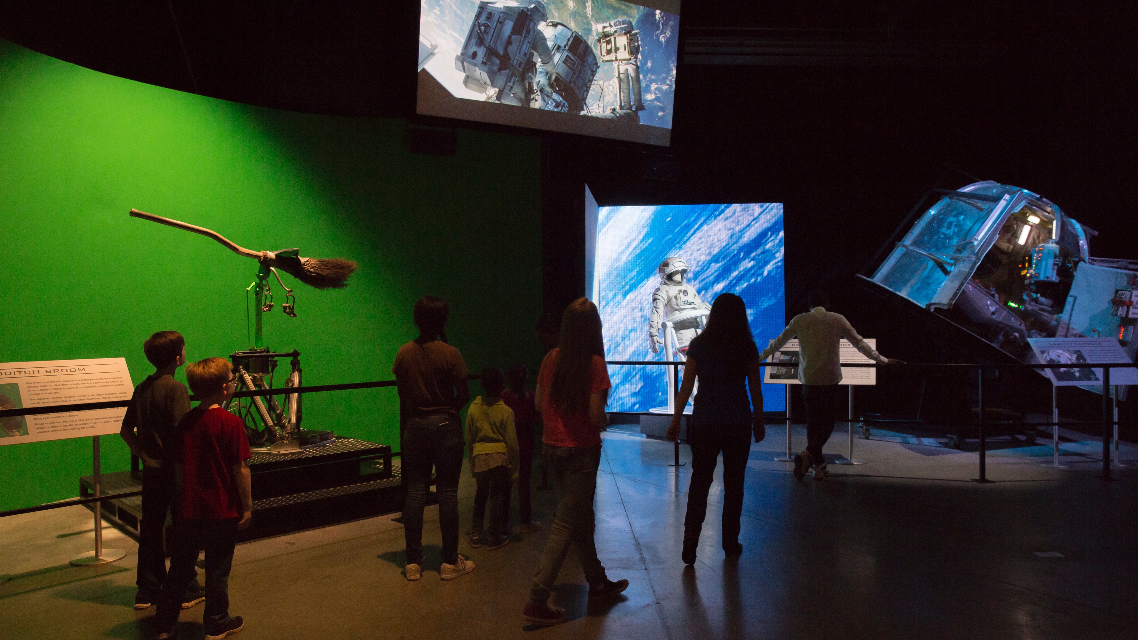 Guests walking through exhibit with Hollywood props