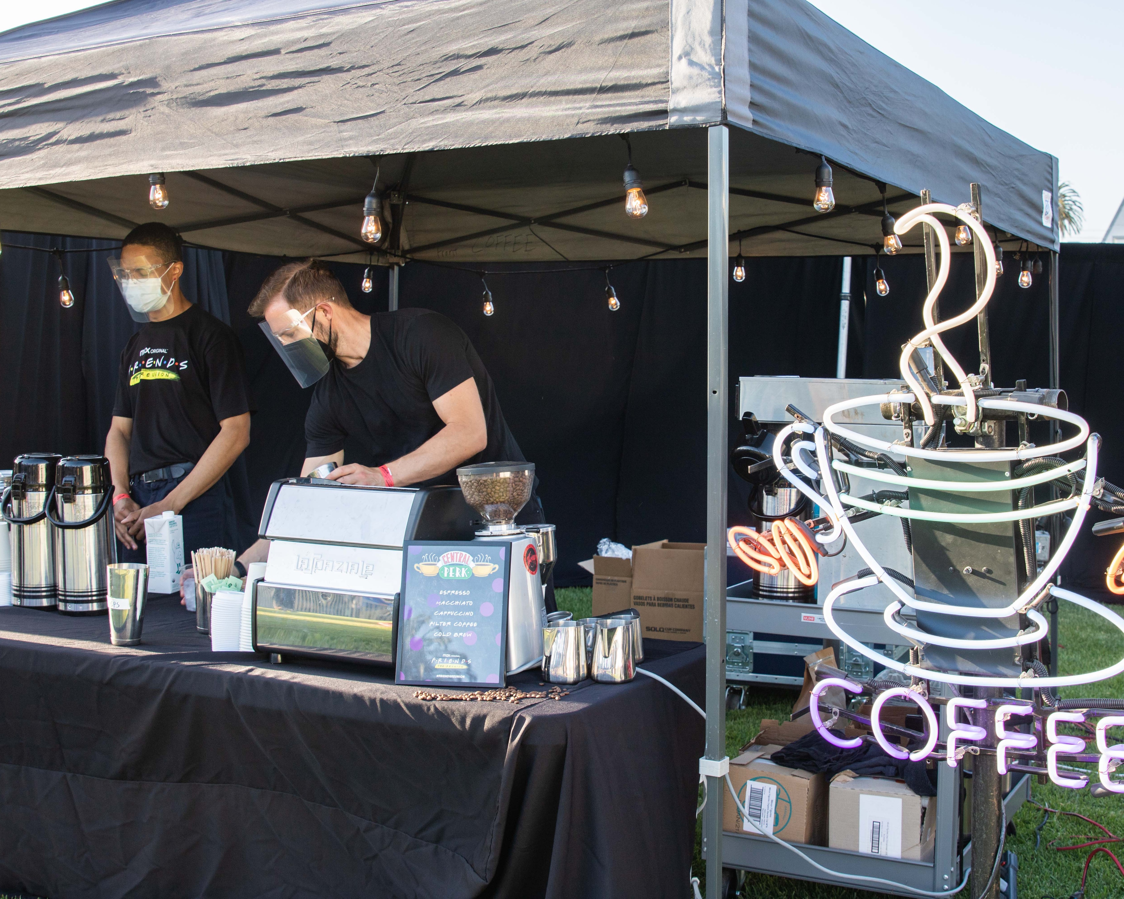 People working at pop up coffee shop on field