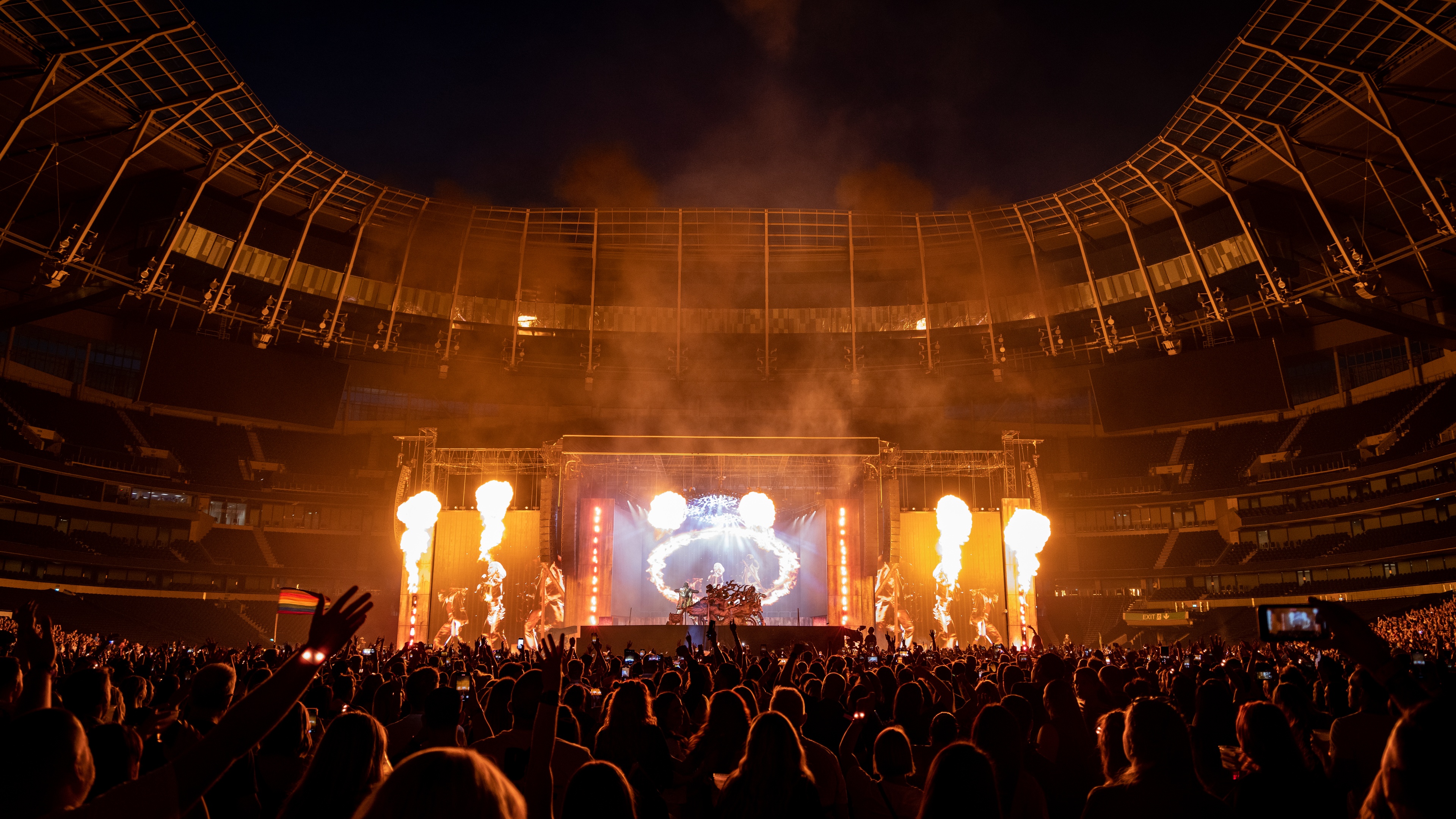 Stage set up in football stadium with crowd and pyro effects