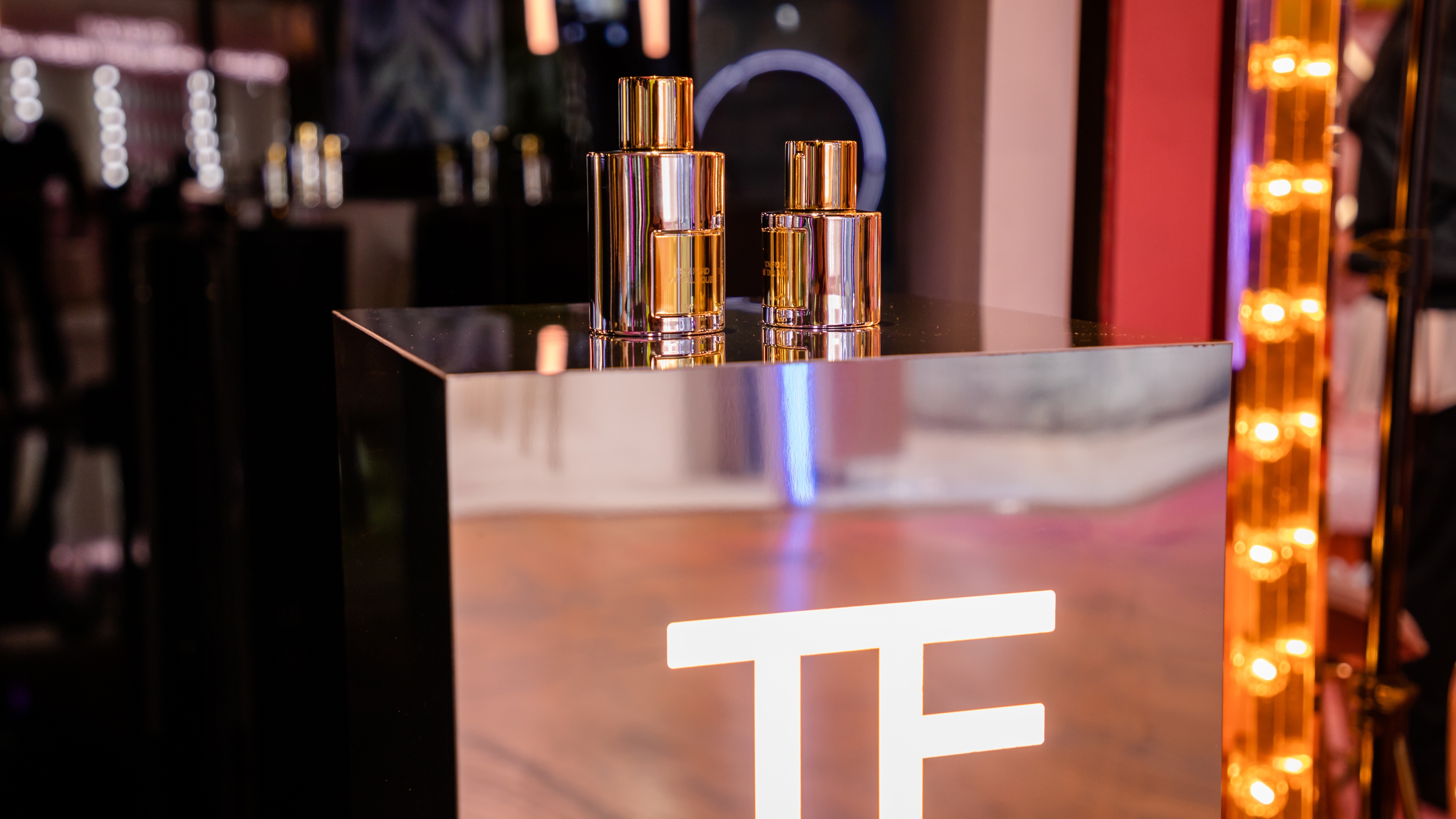 Tom Ford product in gold on top of metallic platform