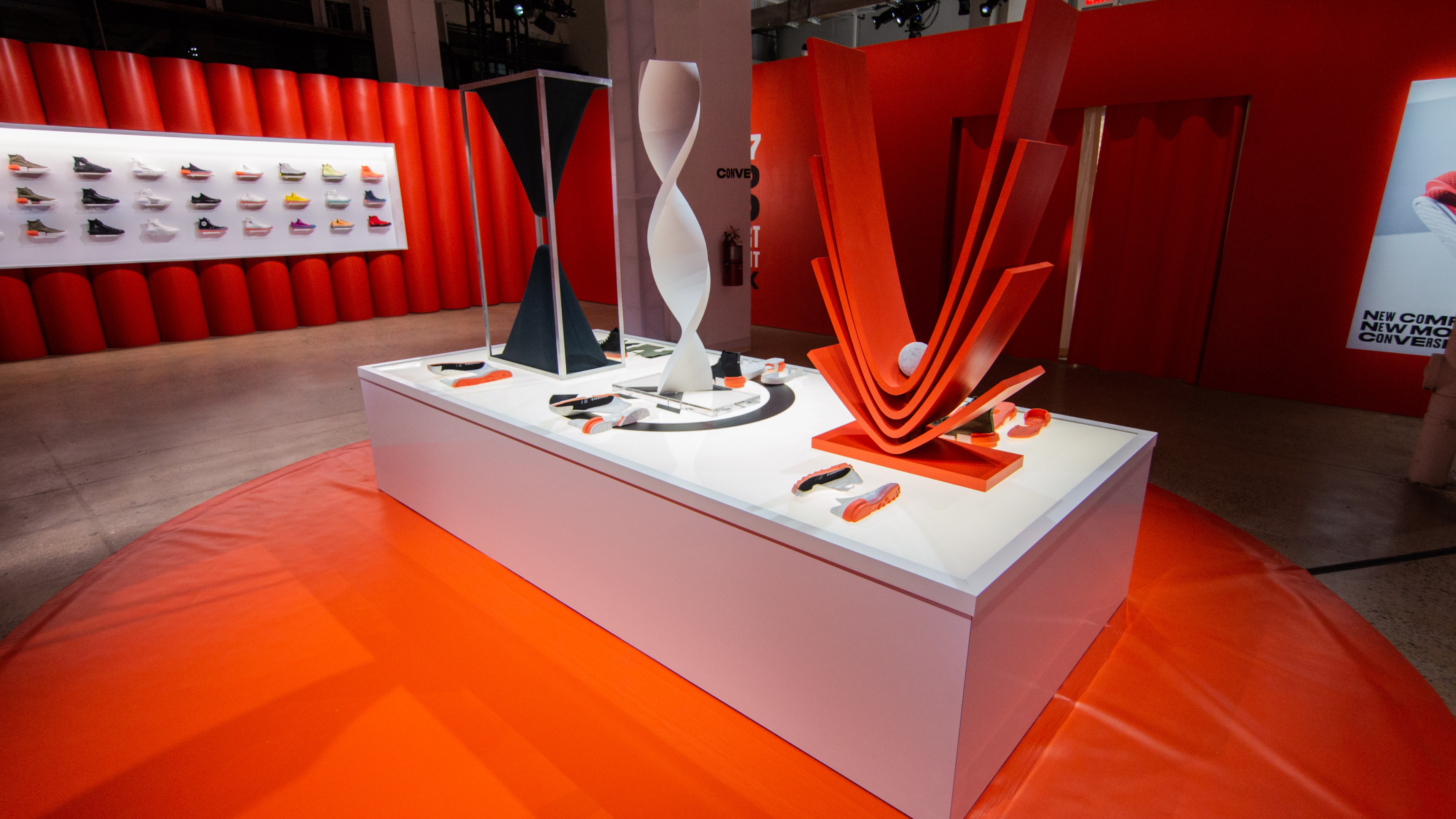 White platform with white black and red art pieces on top