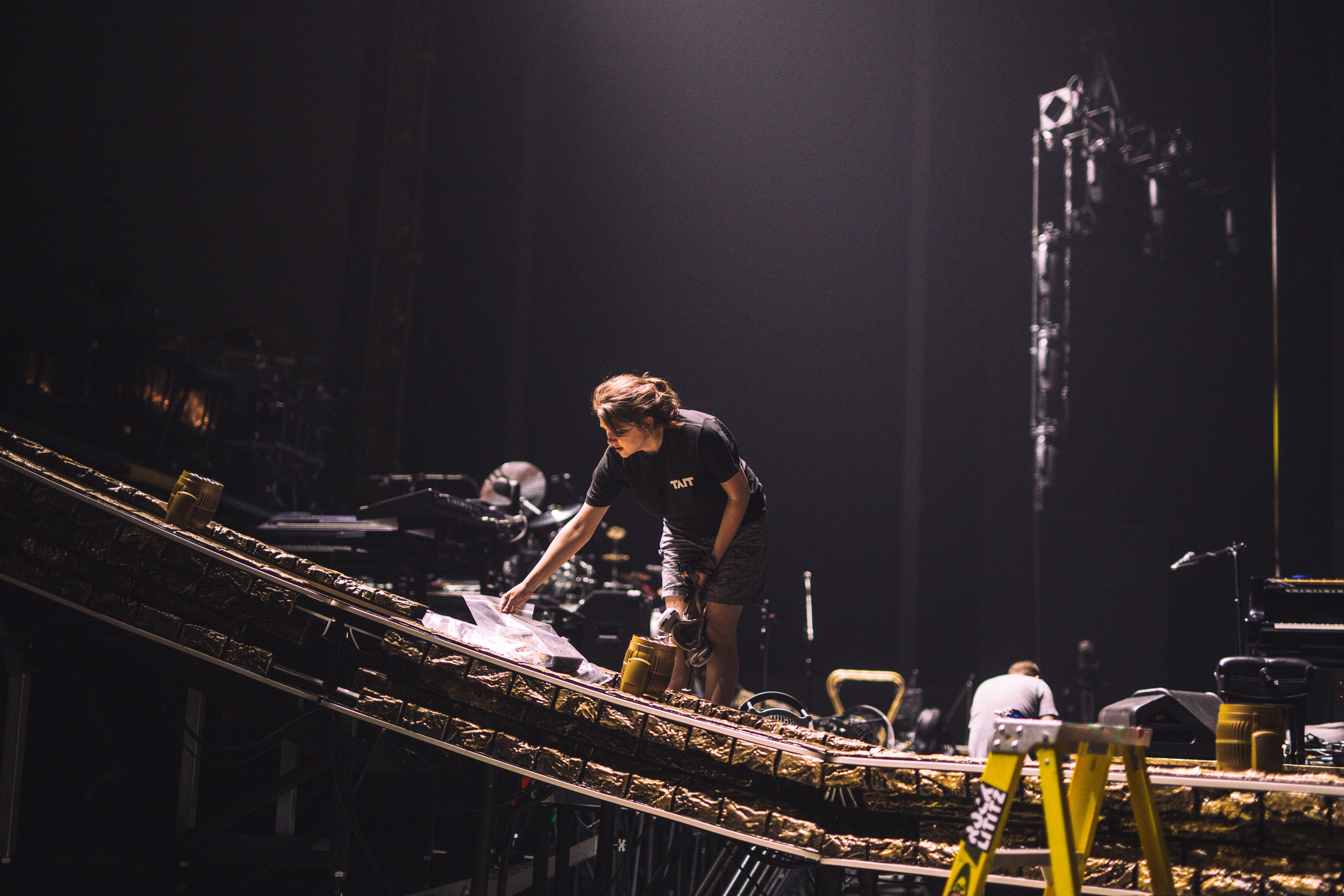 TAIT team member working on curved stage