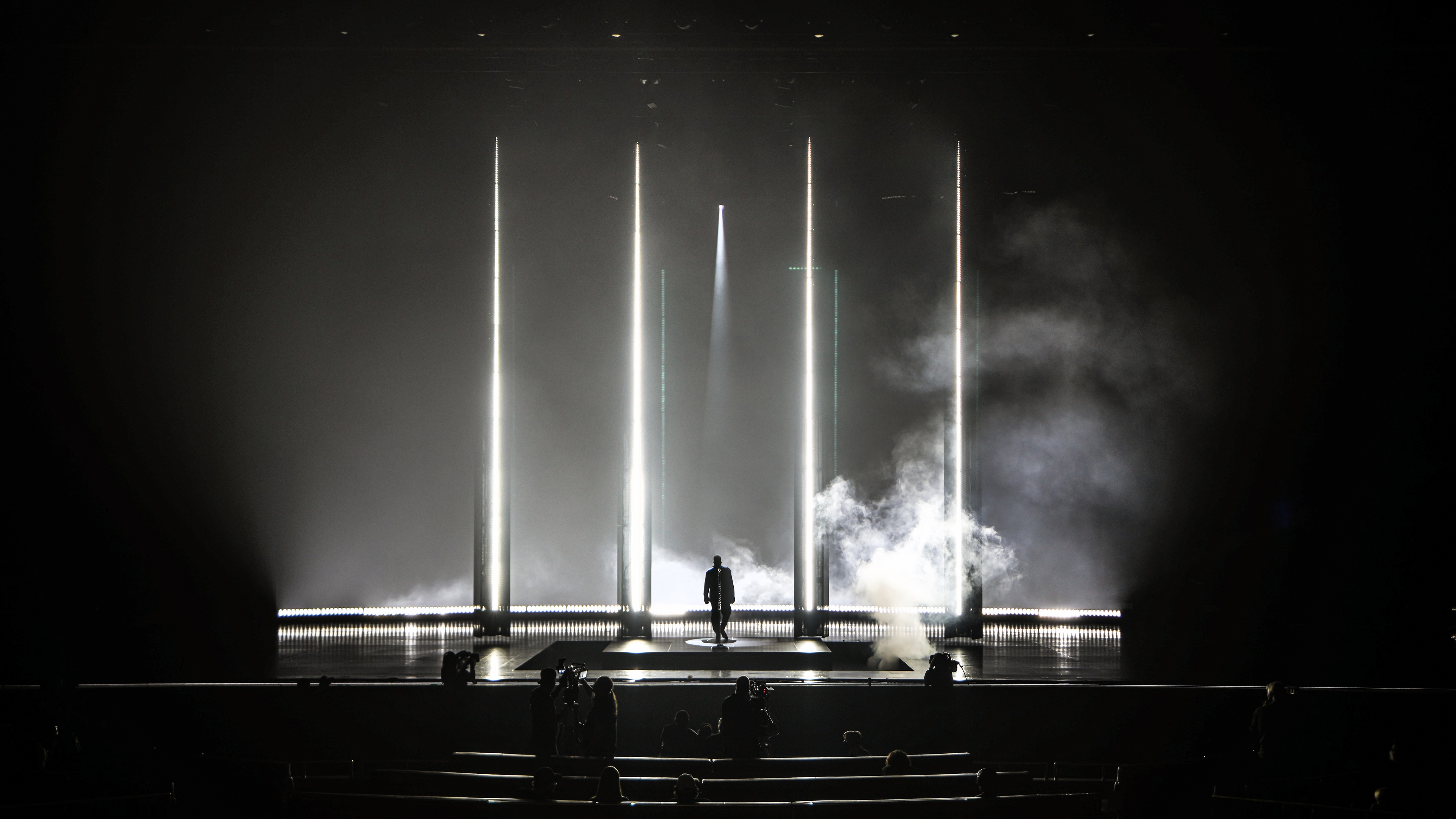 Usher performing at his Residency at The Colosseum at Caesars Palace, black and white stage alluding to space