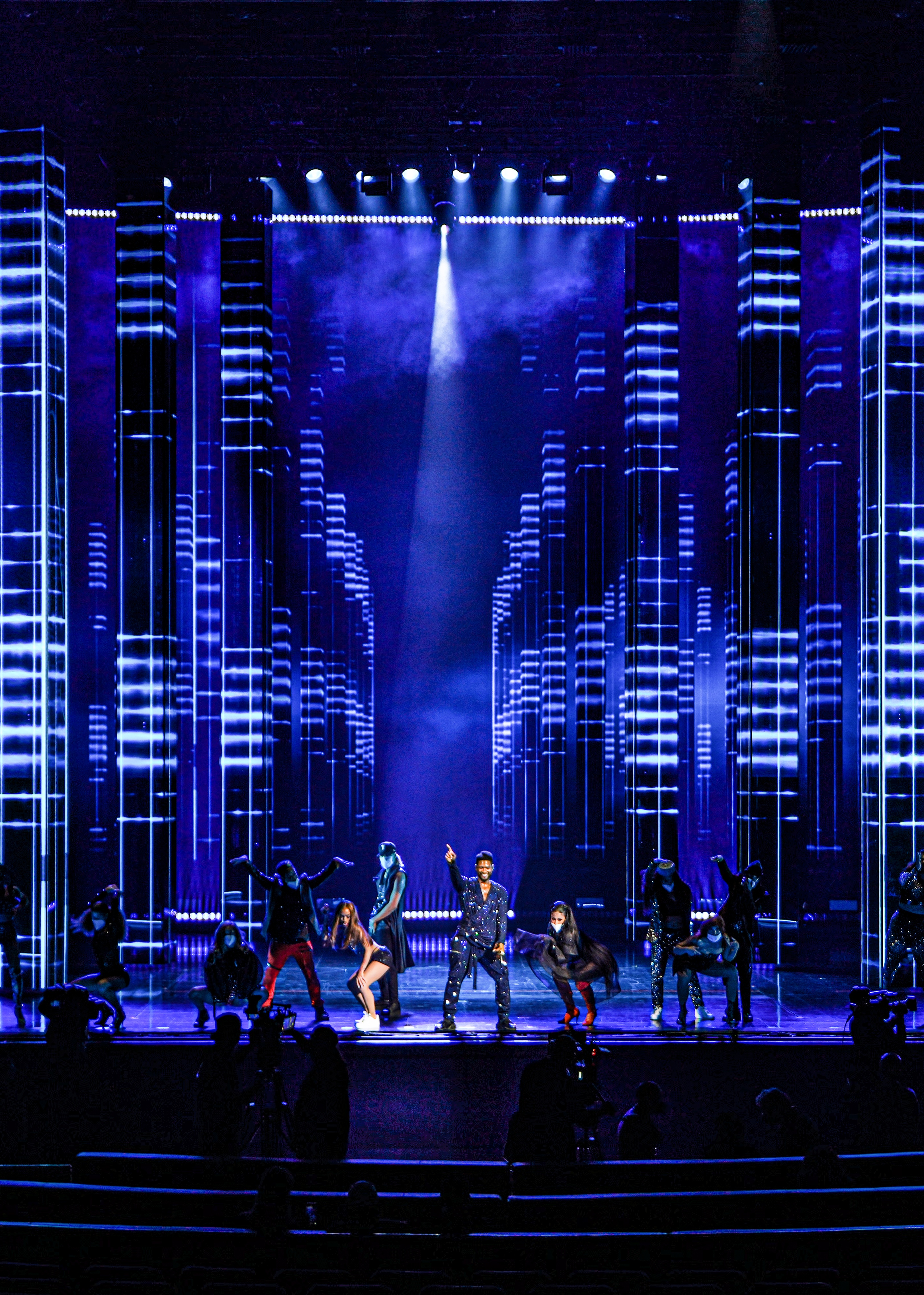 Usher performing with backup dancers at his Residency at The Colosseum at Caesars Palace, blue lit stage