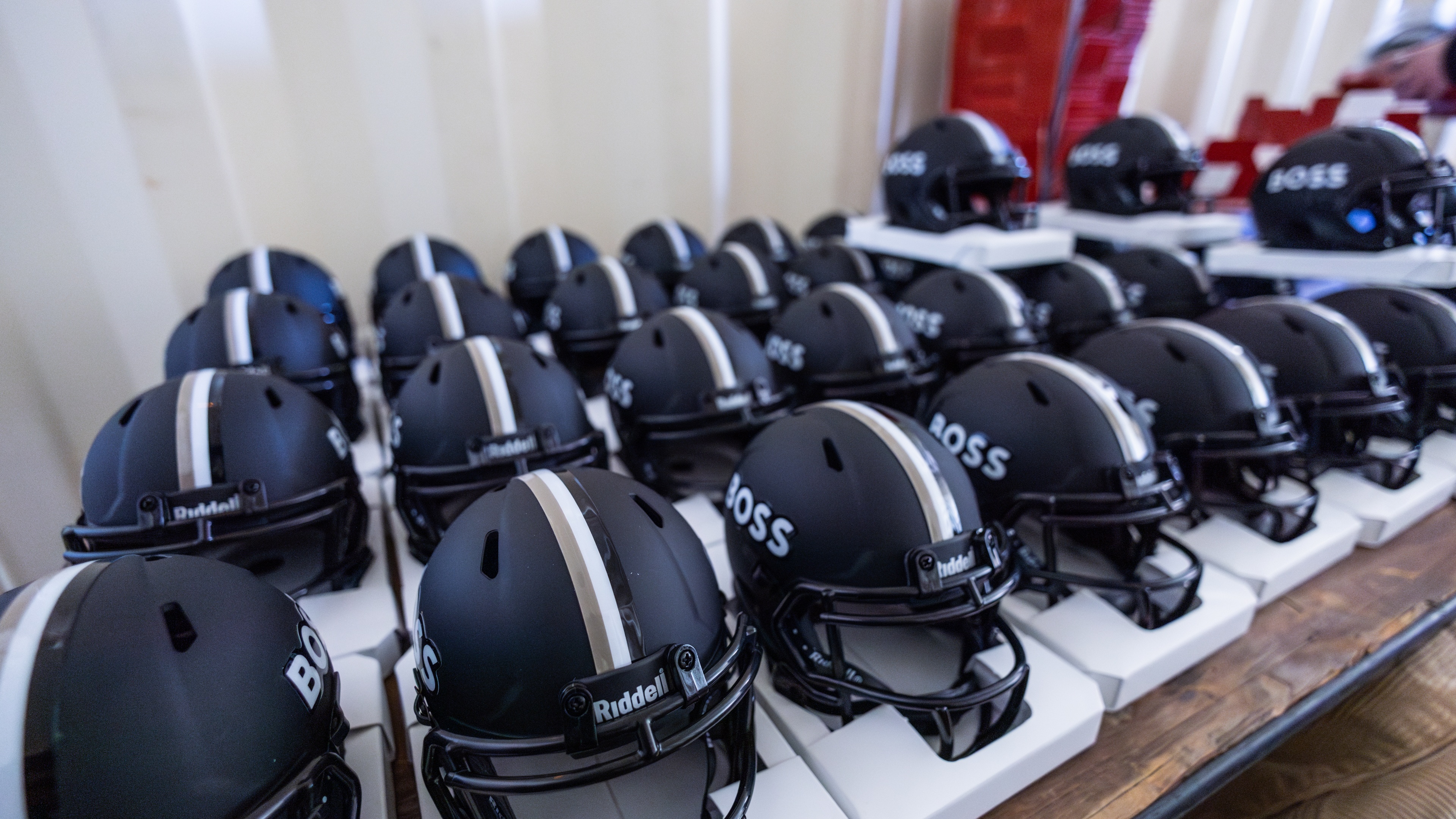 Black BOSS helmets lined up on table