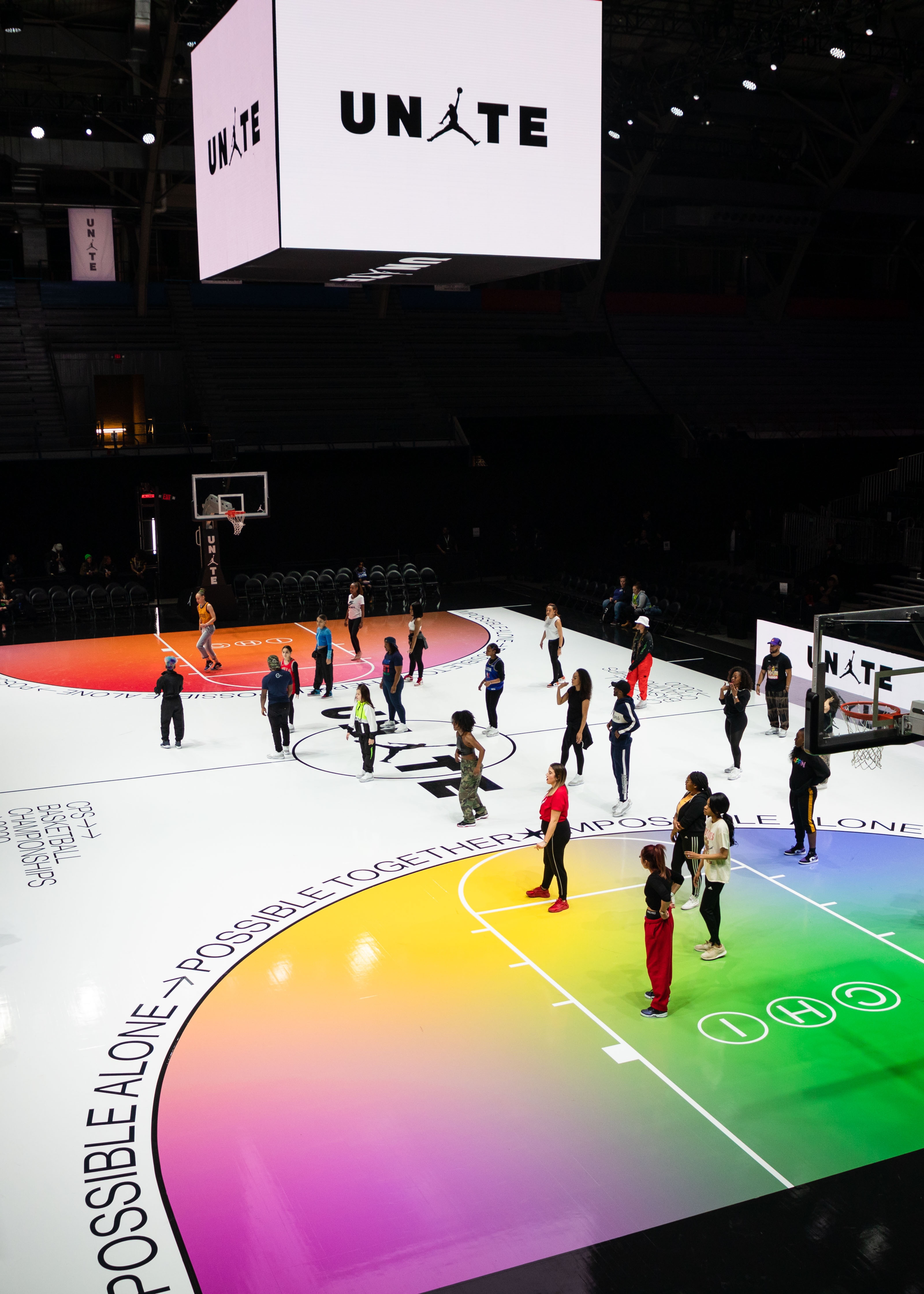 People standing on a colorfully painted basketball court