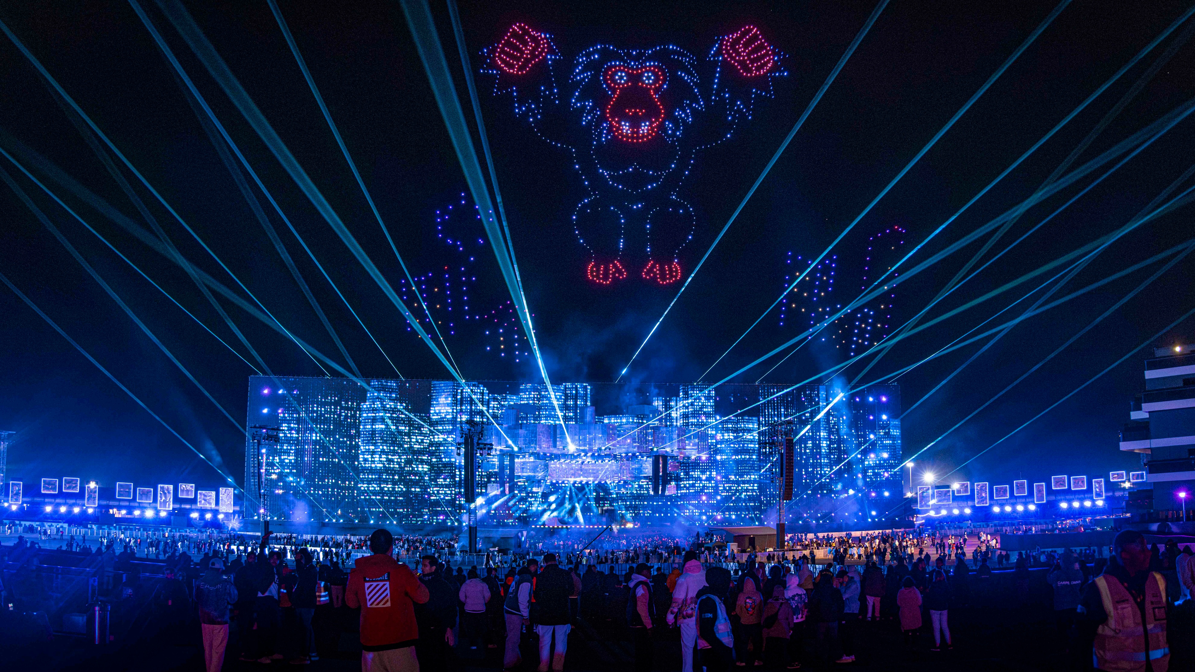 view of large stage with blue lights from the audience at night