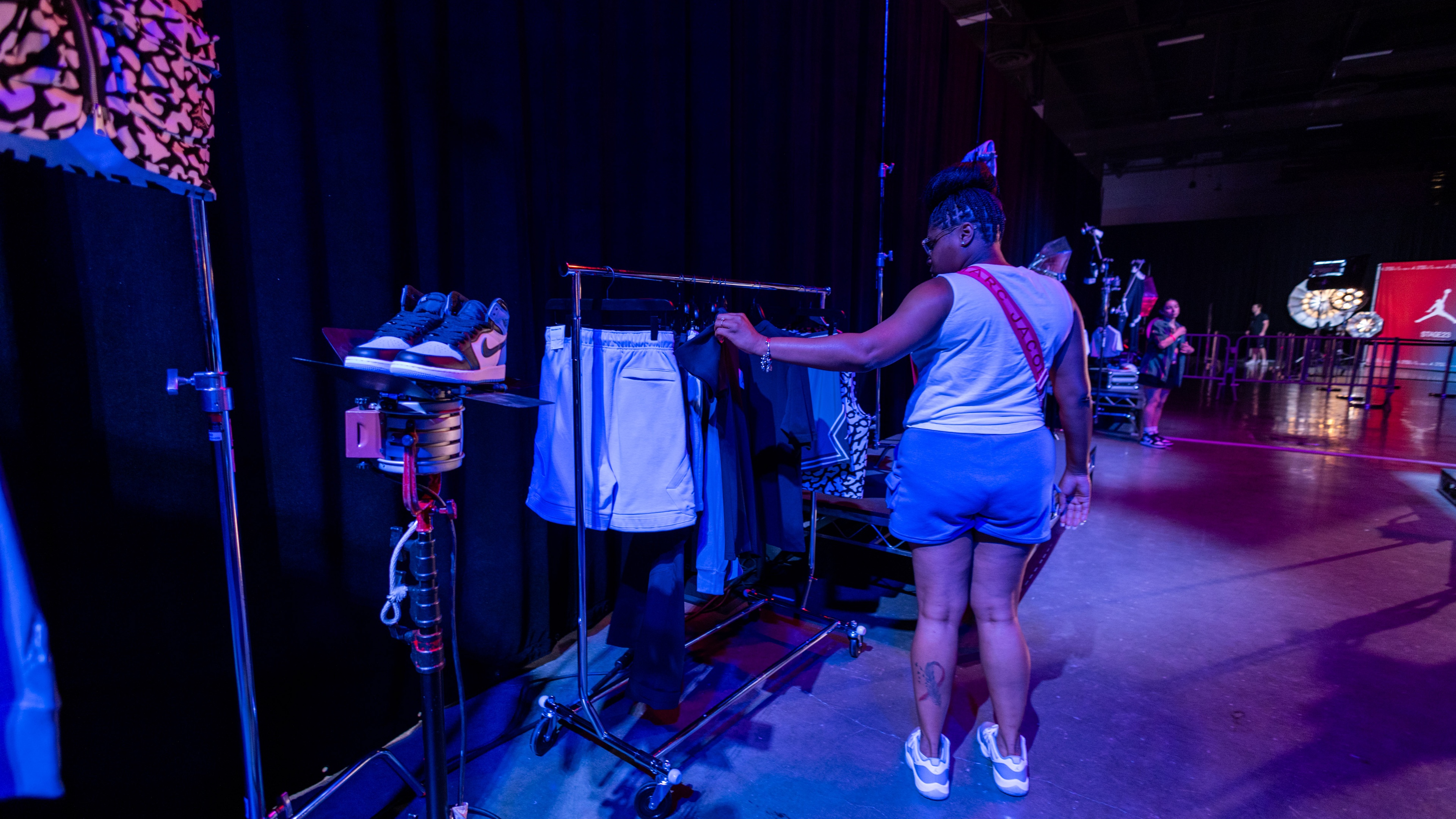 Nike Jordan Brand WNBA All-Star Weekend Las Vegas woman going through rack containing Jordan merchandise