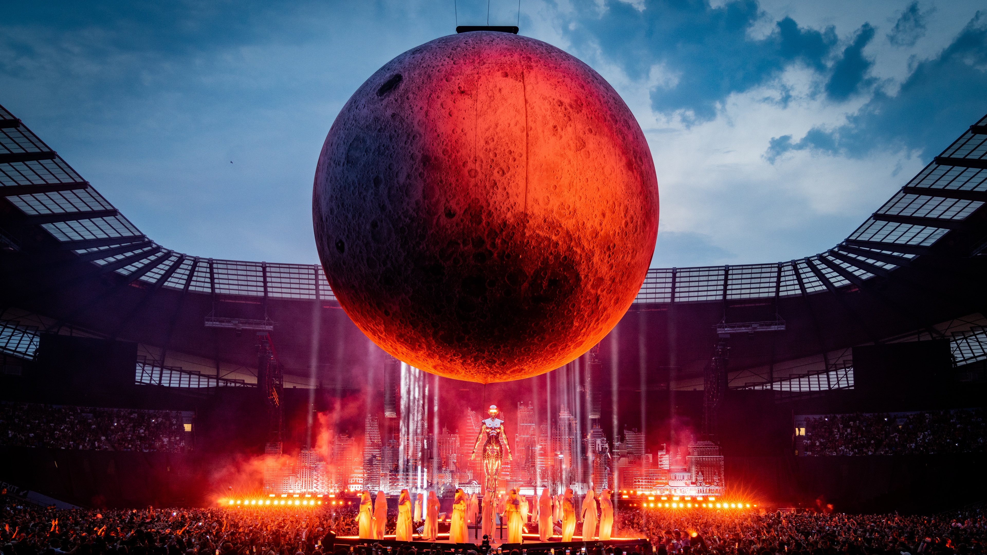 The Weend Stage set up including huge metallic scenic sculpture and red moon in a stadium