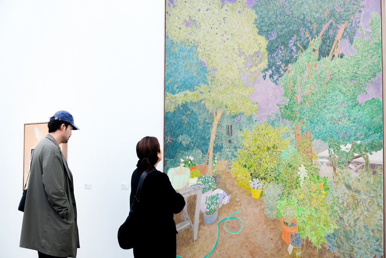 Man and woman viewing large abstract art piece