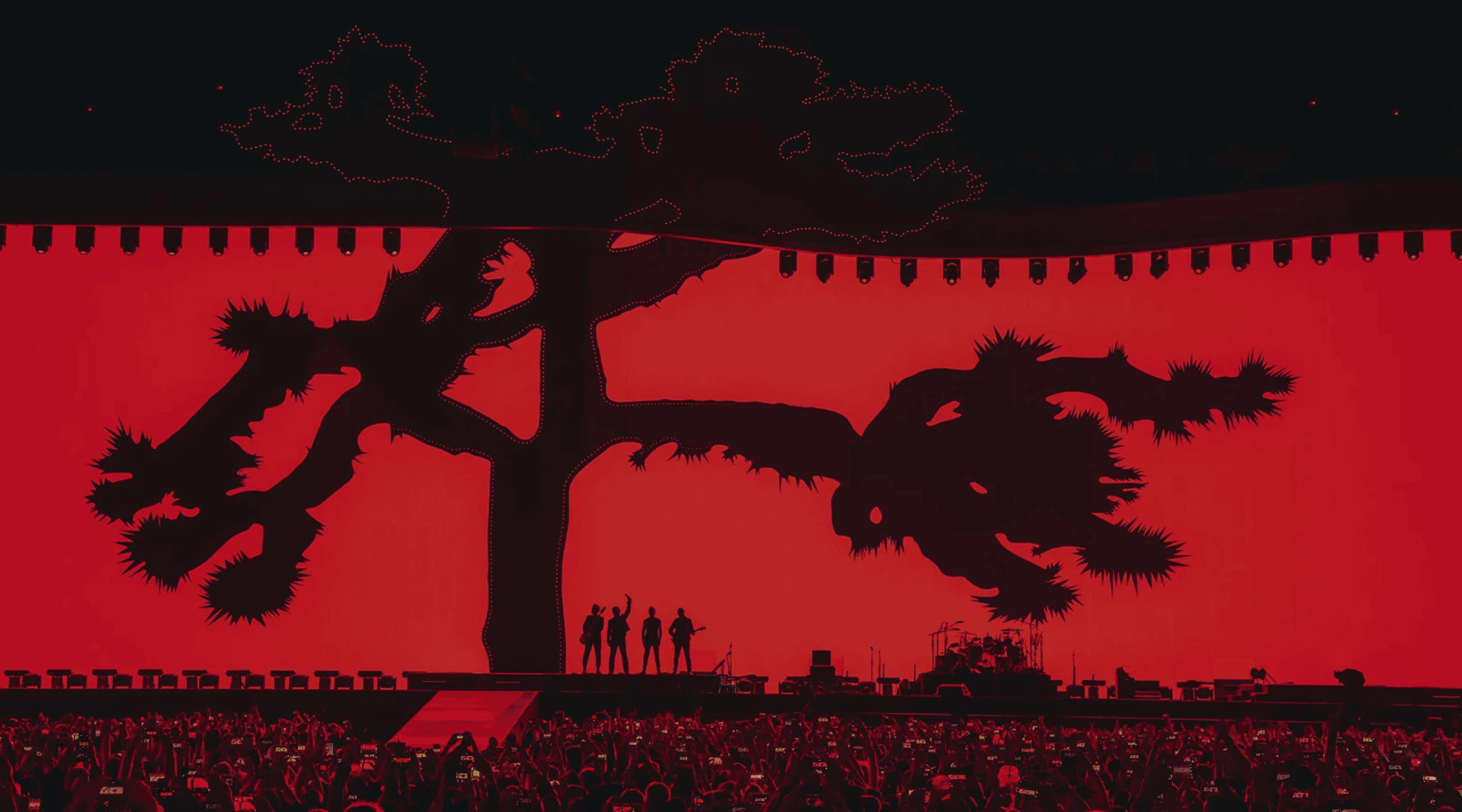 Silhouetted people on red background