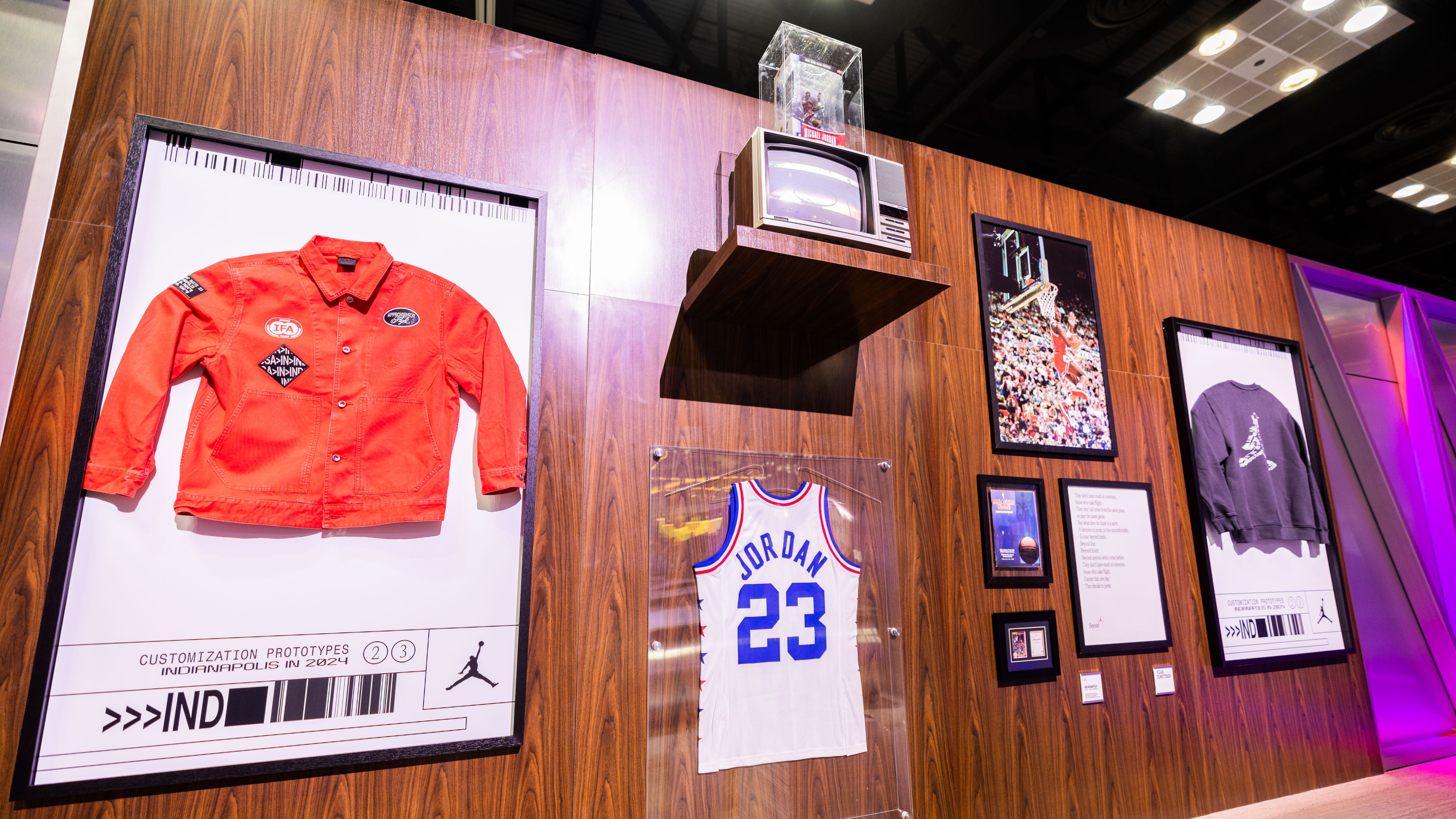 Sports merchandise wall including vintage jackets and basketball jerseys